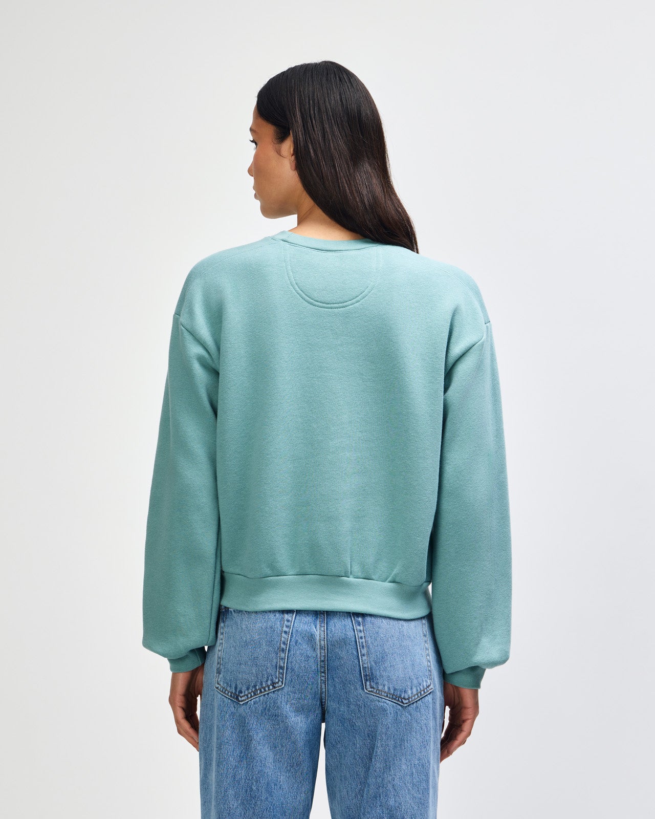 Model wearing an arctic colour sweatshirt pairing with blue jeans (back pose) -arctic