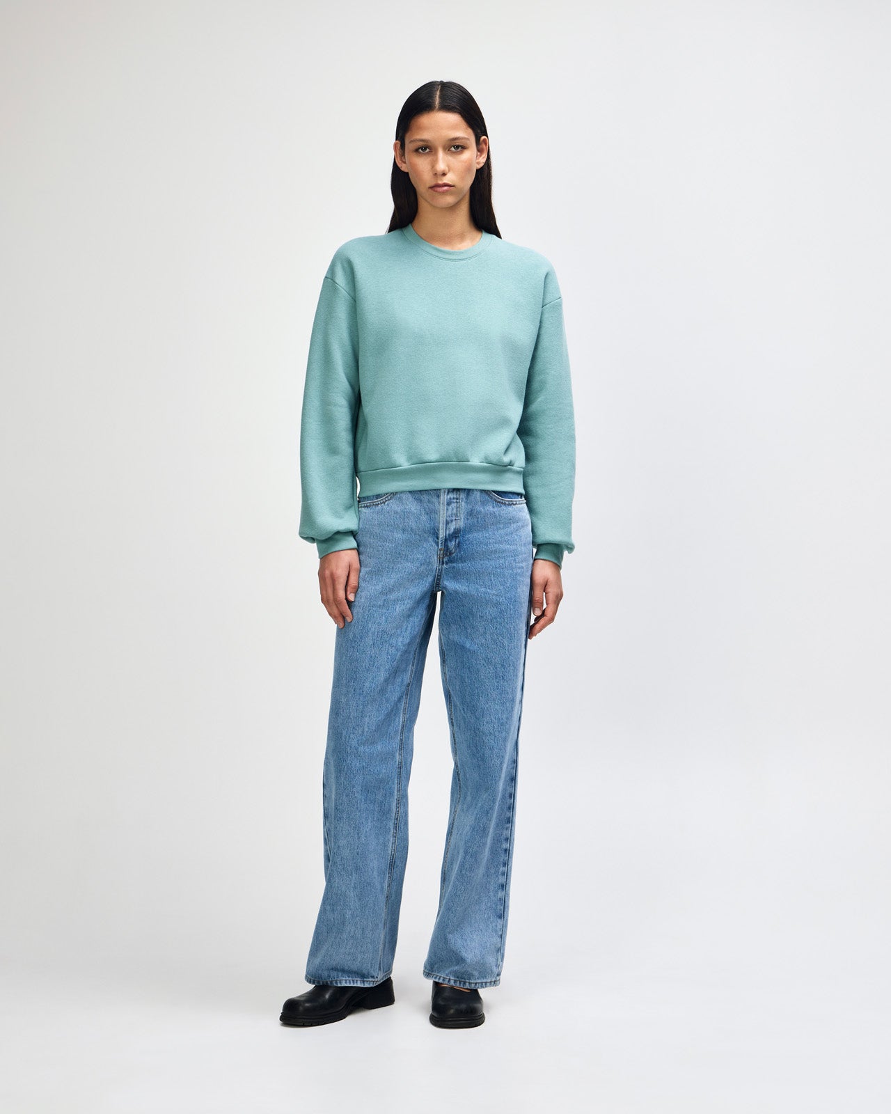Model wearing an arctic colour sweatshirt pairing with blue jeans (front pose) -arctic