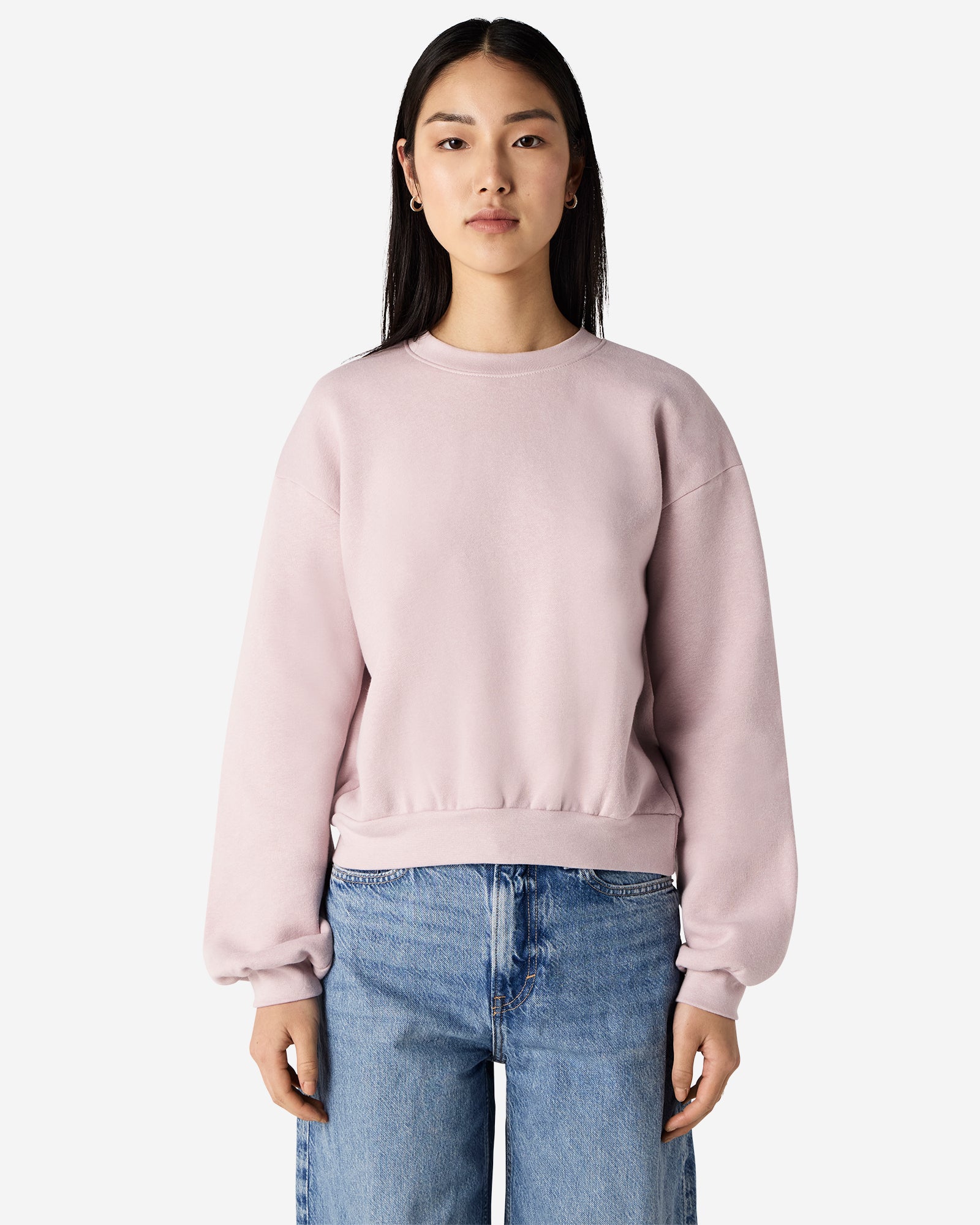 Model wearing a blush colour sweatshirt pairing with blue jeans (front pose) -blush