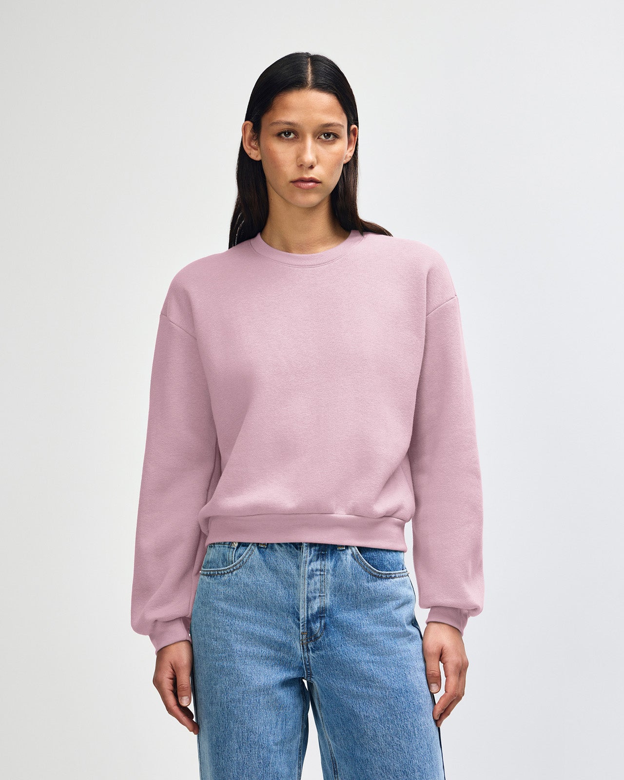 Model wearing a blush colour sweatshirt pairing with blue jeans (front pose) -blush
