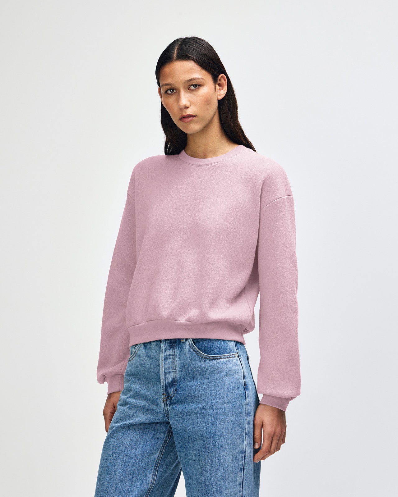 Model wearing a blush colour sweatshirt pairing with blue jeans (front pose) -blush