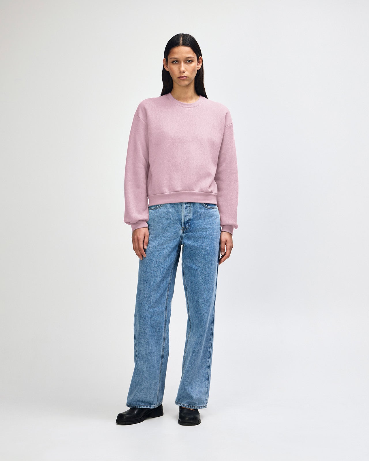 Model wearing a blush colour sweatshirt pairing with blue jeans (front pose) -blush