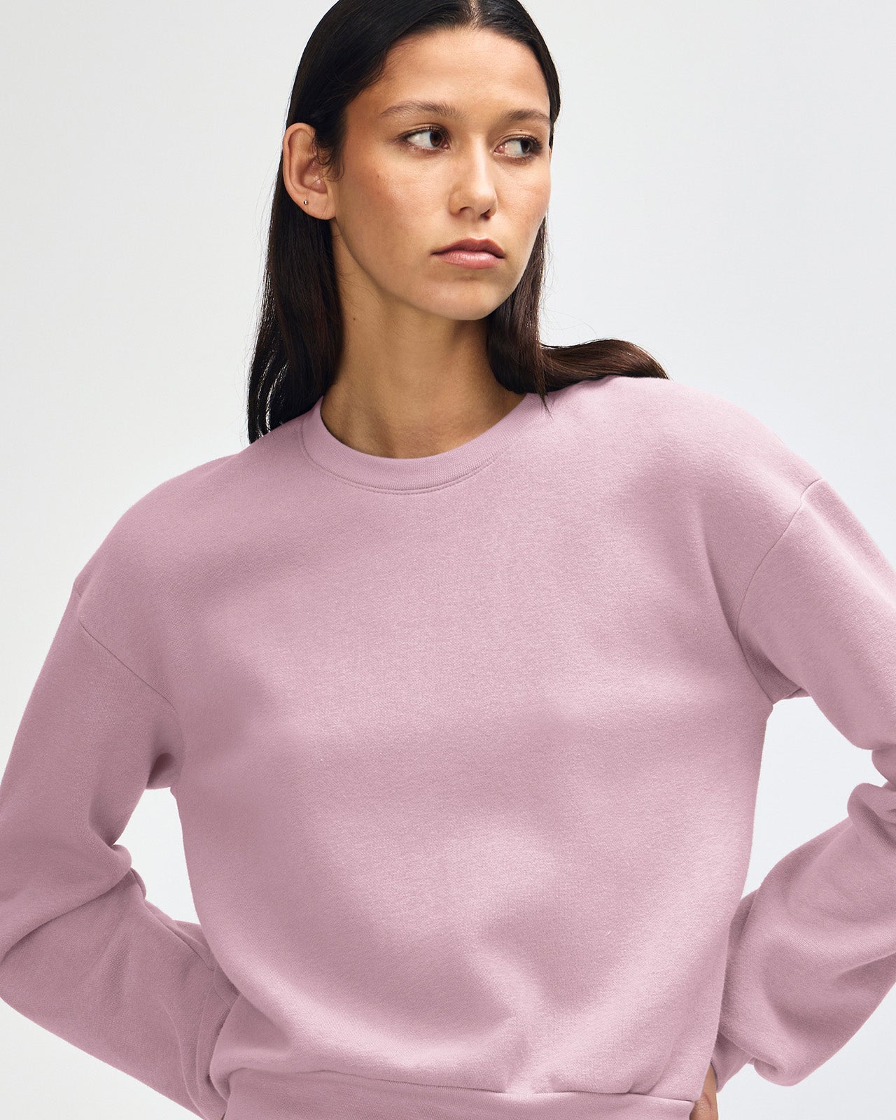Model wearing a blush colour sweatshirt pairing with blue jeans (front pose) -blush