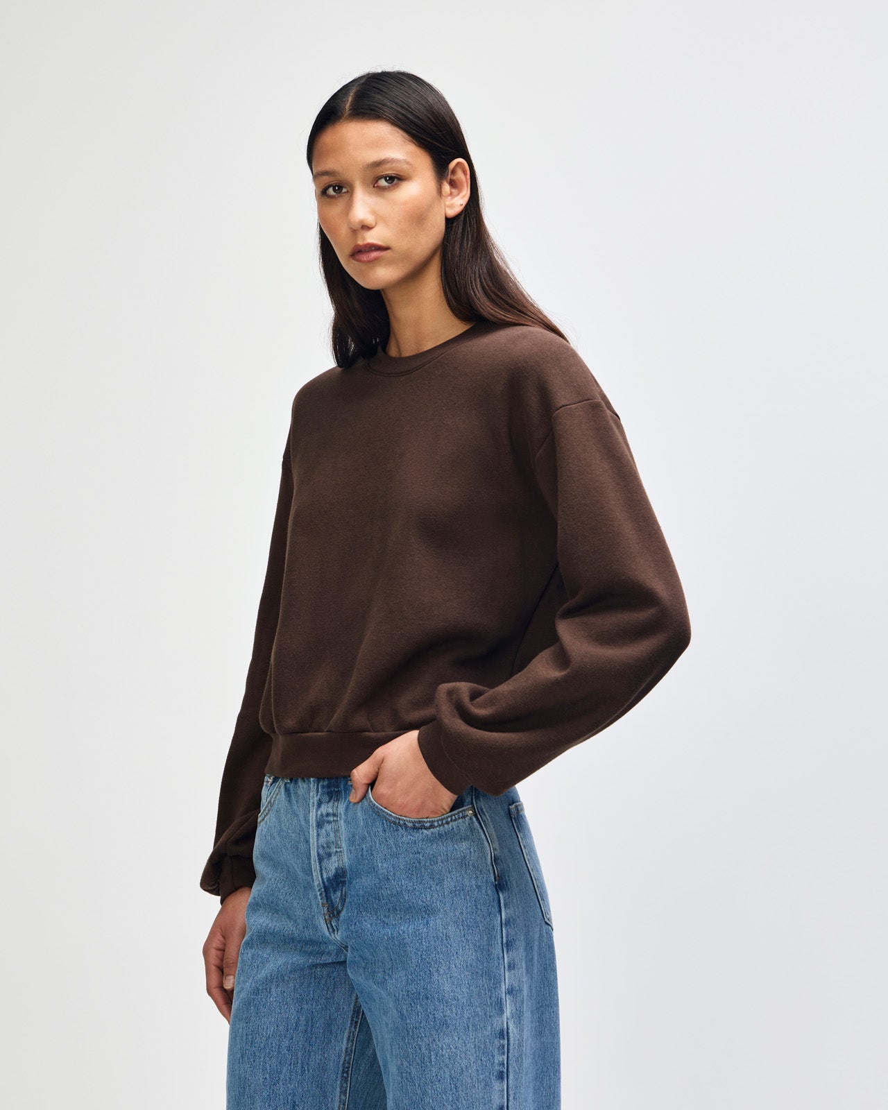 Model wearing a brown colour sweatshirt pairing with blue jeans (front pose) -brown
