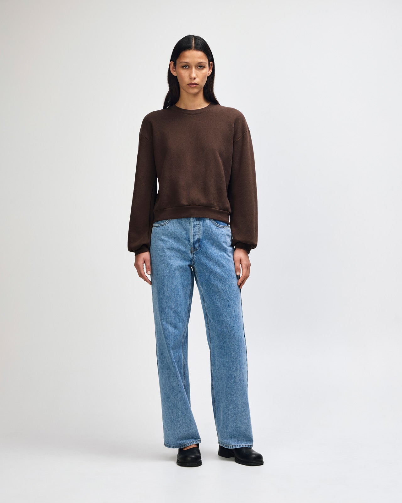 Model wearing a brown colour sweatshirt pairing with blue jeans (front pose) -brown