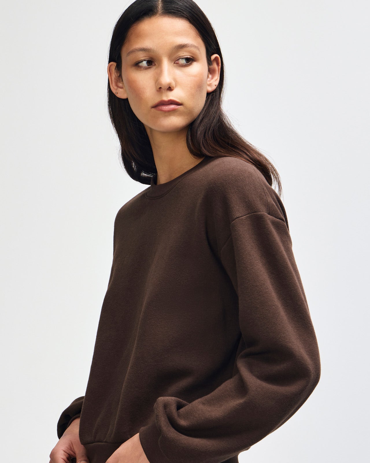 Model wearing a brown colour sweatshirt pairing with blue jeans (front pose) -brown