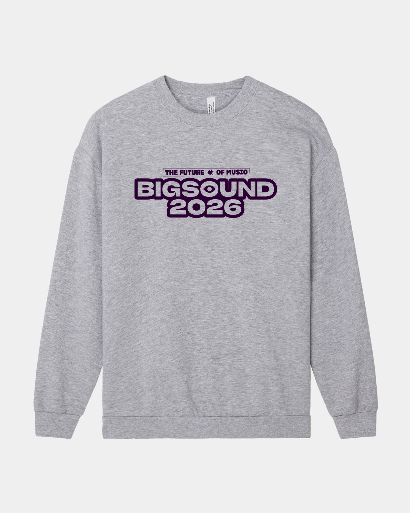 A heather gray crewneck sweatshirt with a graphic print on the chest reading 'THE FUTURE IS OF MUSIC BIGSOUND 2026' in purple and black, displayed on a light gray background -Heather Gray