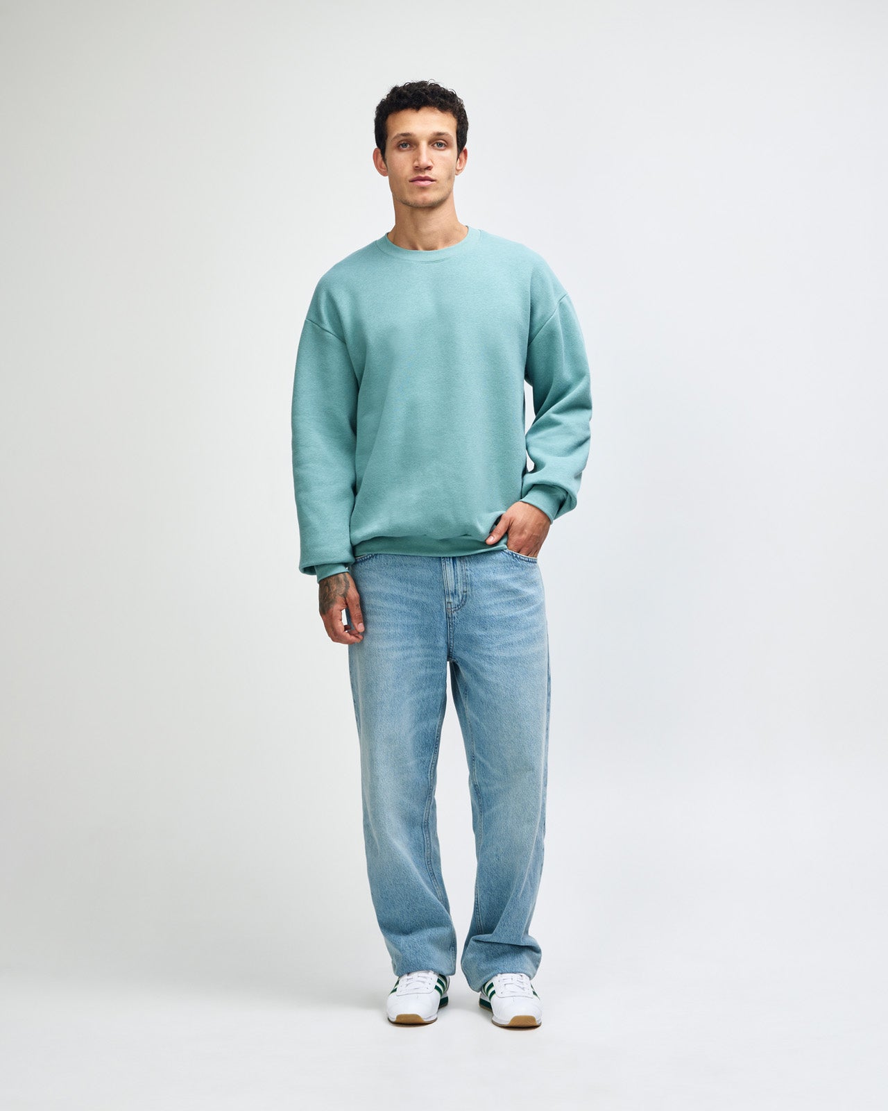 Male model wearing a Reflex Unisex Crewneck Sweatshirt (front pose) -arctic