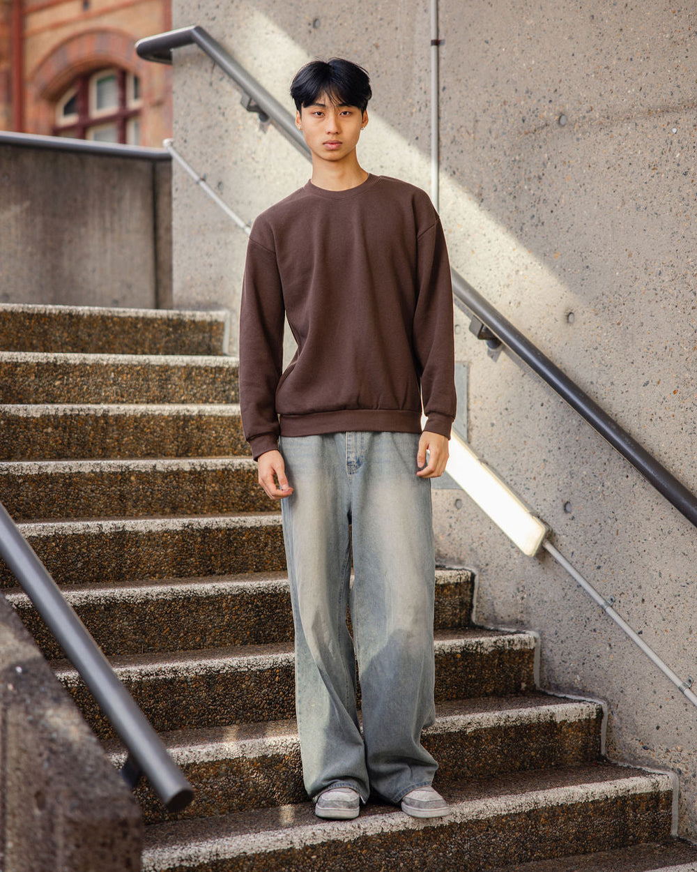 image of Unisex Sweatshirt : Male model wearing a Reflex Unisex Crewneck Sweatshirt (front pose) -brown