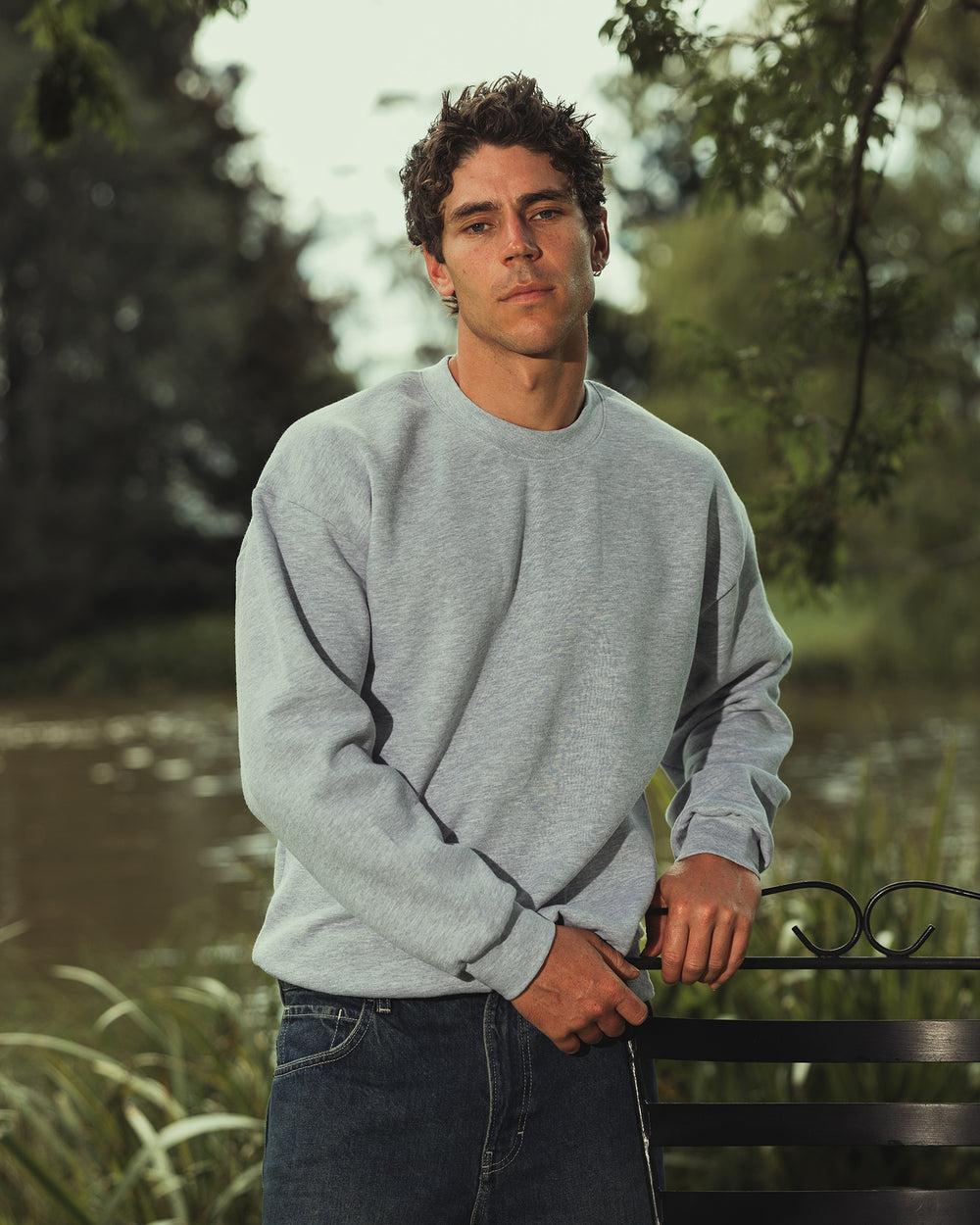 image of Unisex Sweatshirt : Male model wearing a Reflex Unisex Crewneck Sweatshirt (front pose) -heather grey