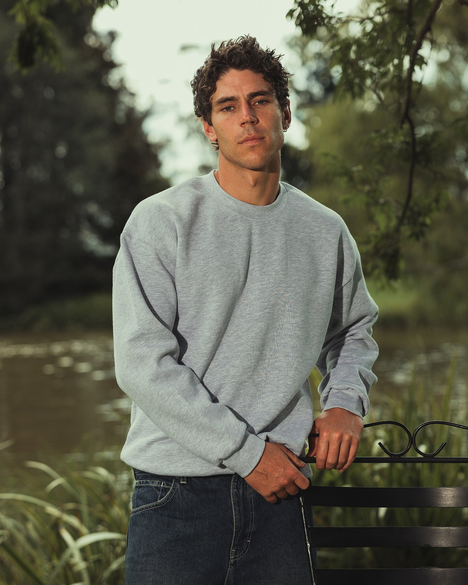Male model wearing a Reflex Unisex Crewneck Sweatshirt (front pose) -heather grey