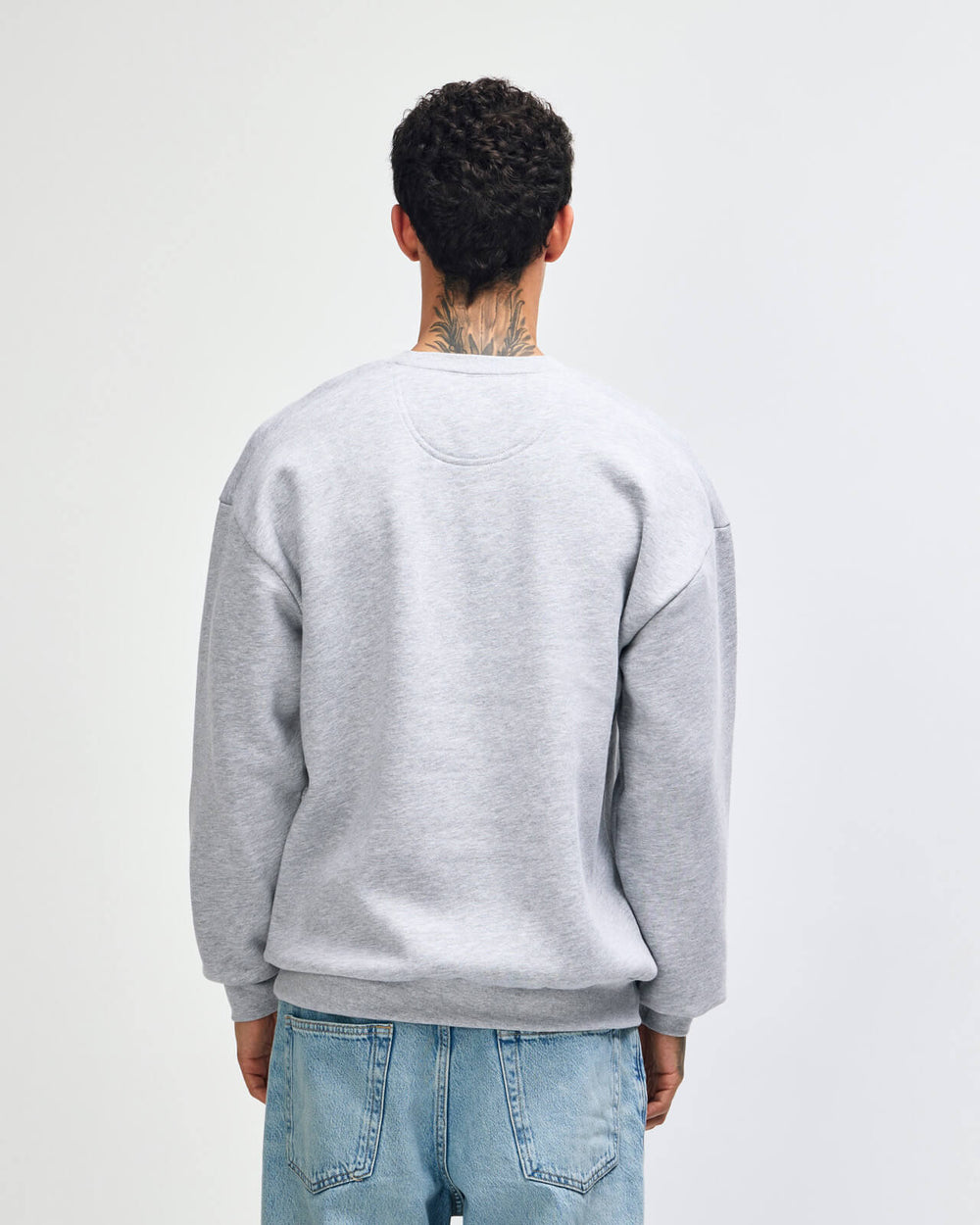 next image of Crewneck Sweatshirt Tracksuit Set - Embroidered Logo - Heather Grey : Person wearing a gray sweatshirt and blue jeans on a plain background -Heather Grey