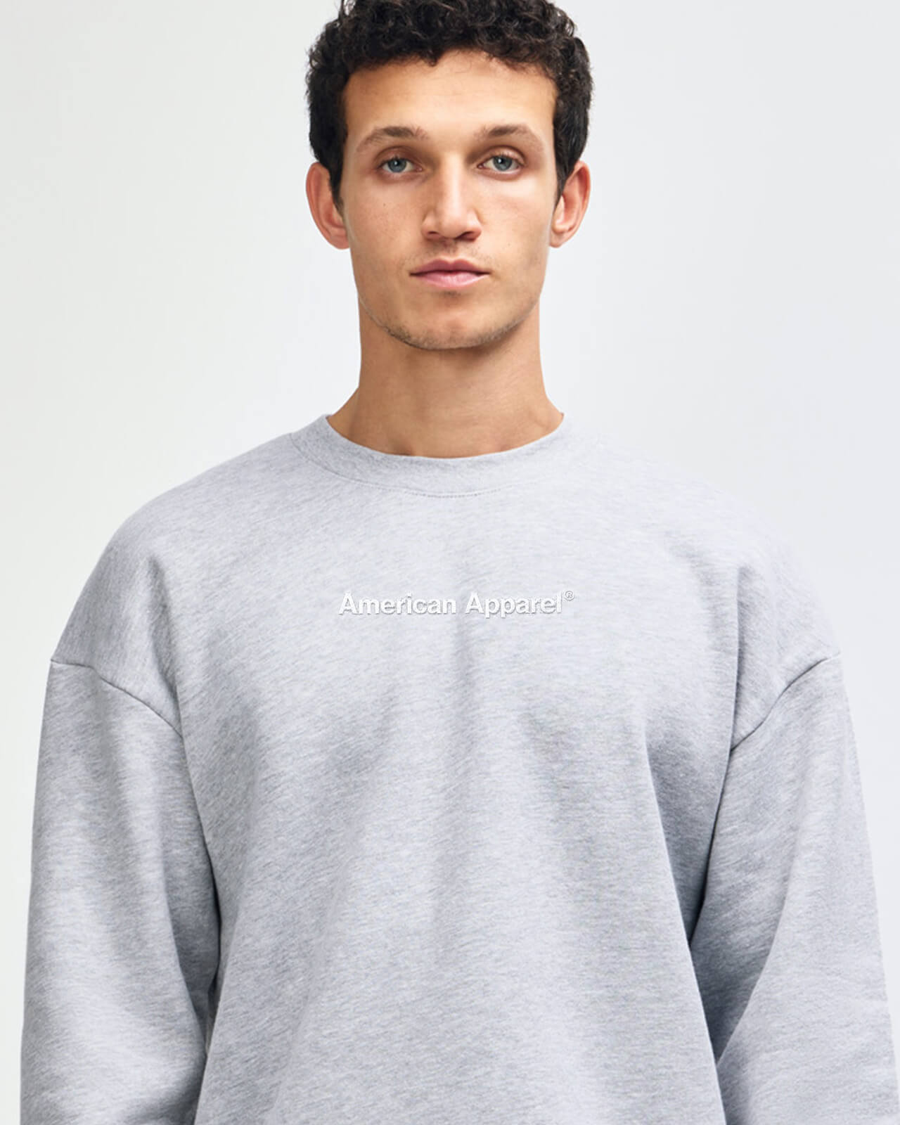 Man wearing a gray American Apparel sweatshirt on a white background -Heather Grey