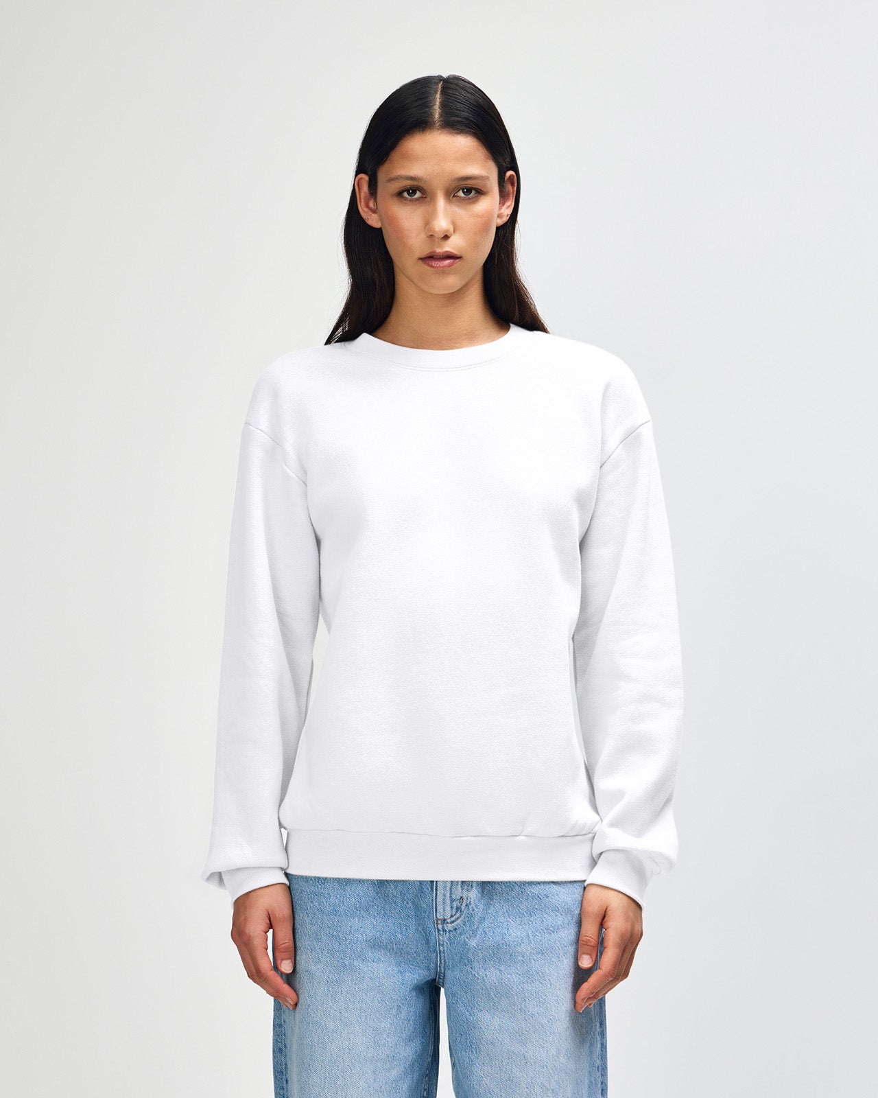 Female model wearing a Reflex Unisex Crewneck Sweatshirt (front pose) -white