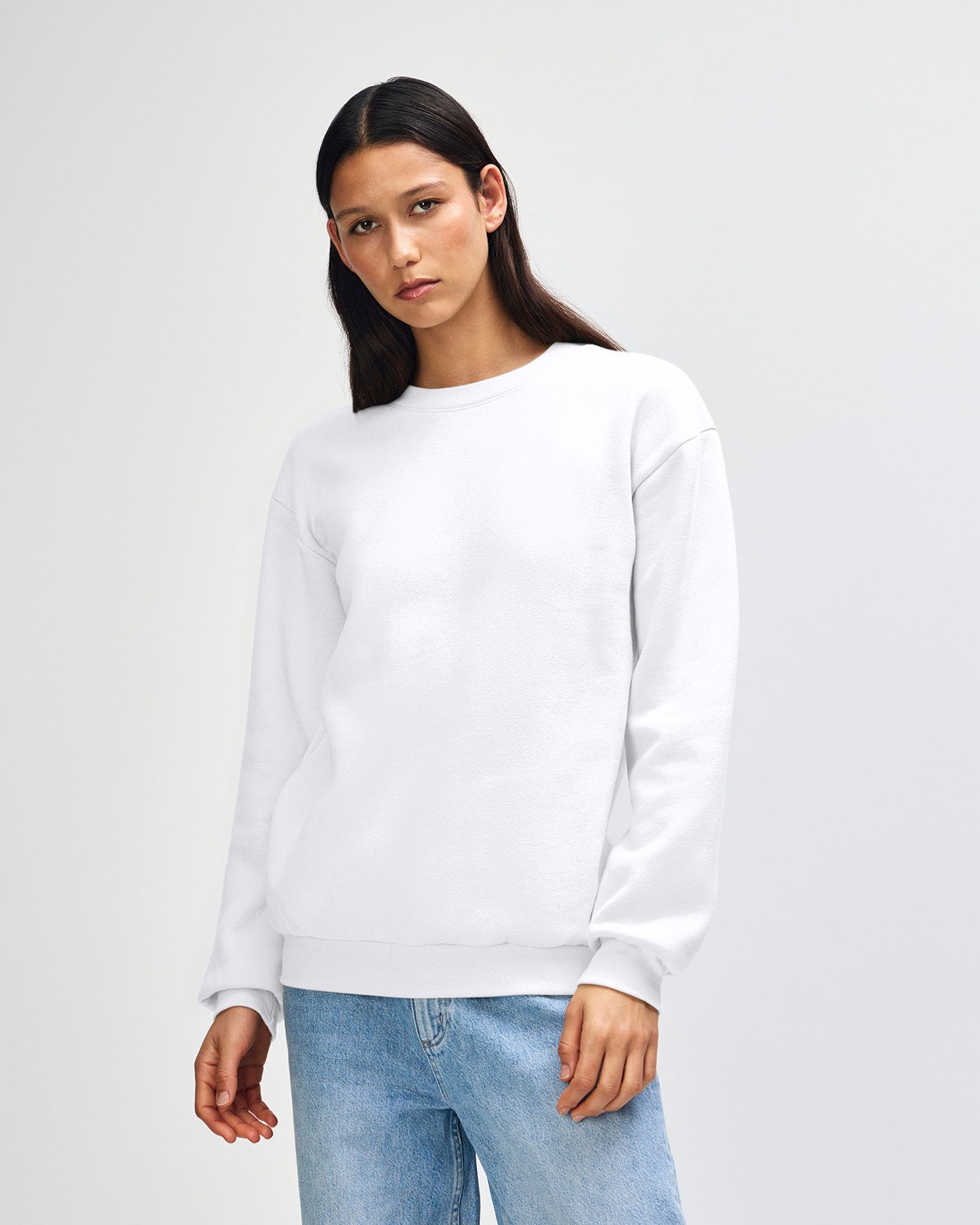 Female model wearing a Reflex Unisex Crewneck Sweatshirt (front pose) -white