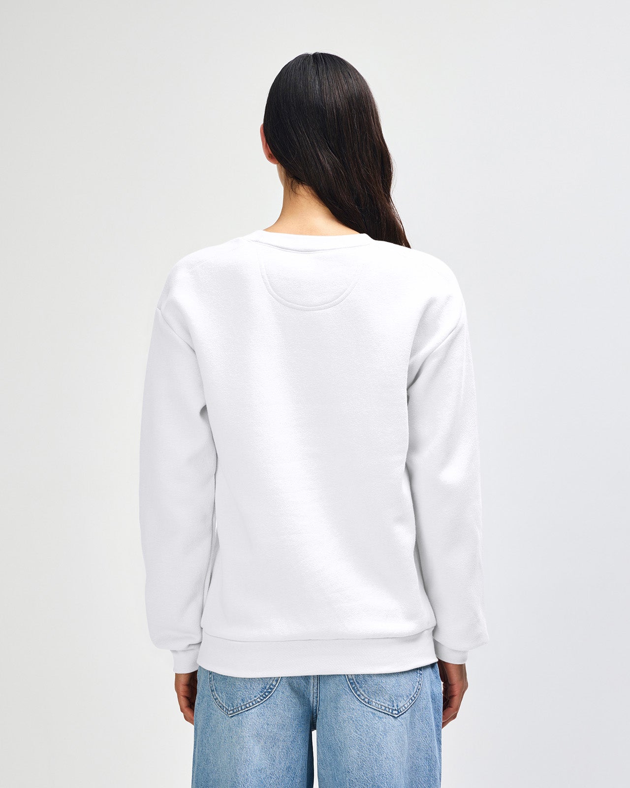 Female model wearing a Reflex Unisex Crewneck Sweatshirt (front pose) -white