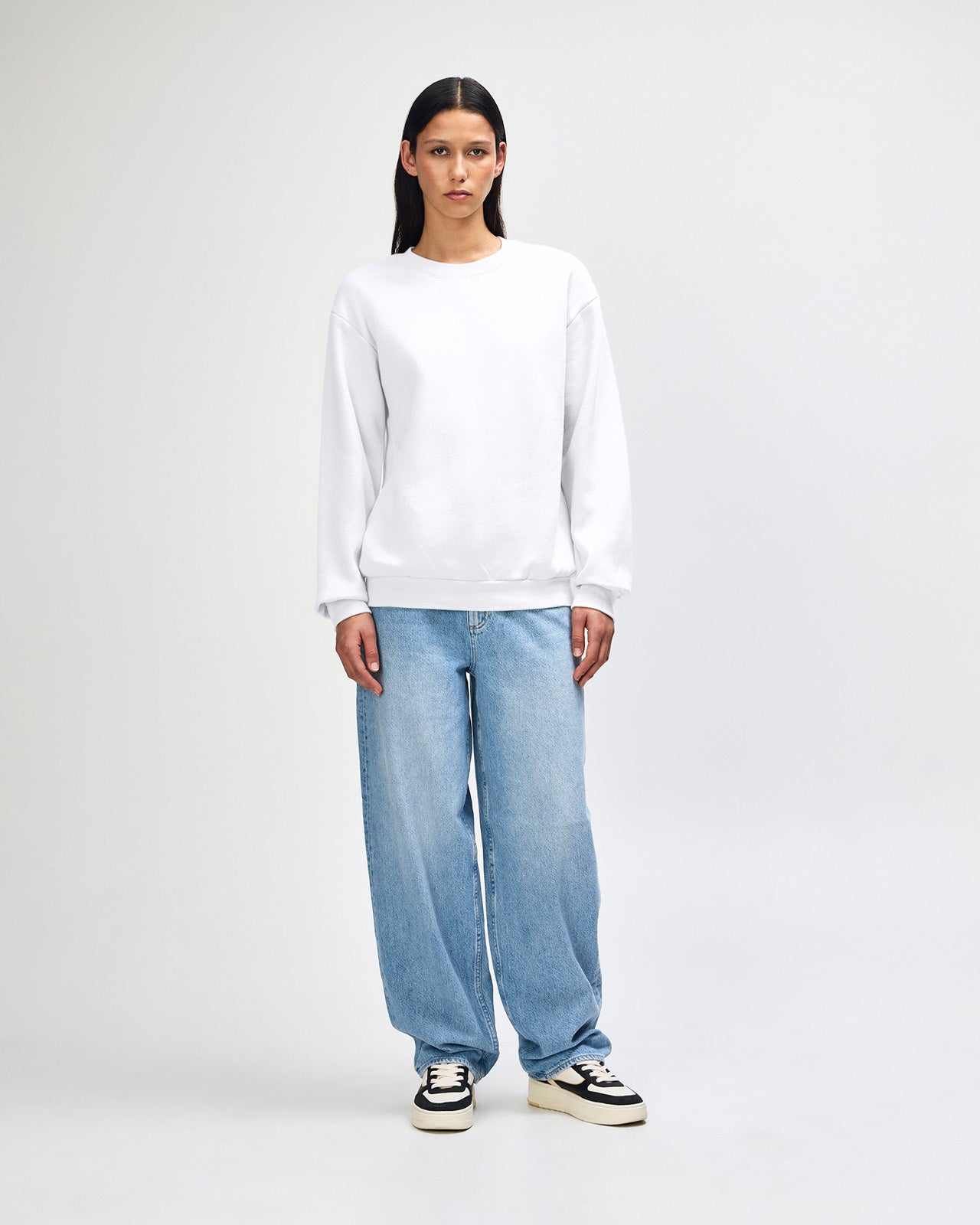 Female model wearing a Reflex Unisex Crewneck Sweatshirt (front pose) -white