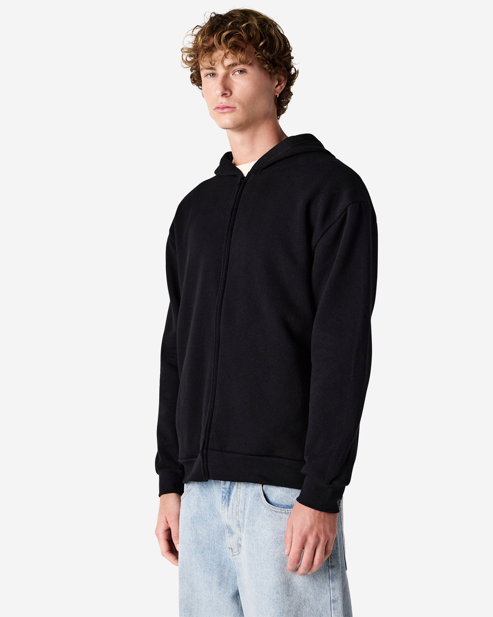 Male model wearing Reflex Unisex Full Zip Hooded Sweatshirt pairing with blue jeans (front pose) -black