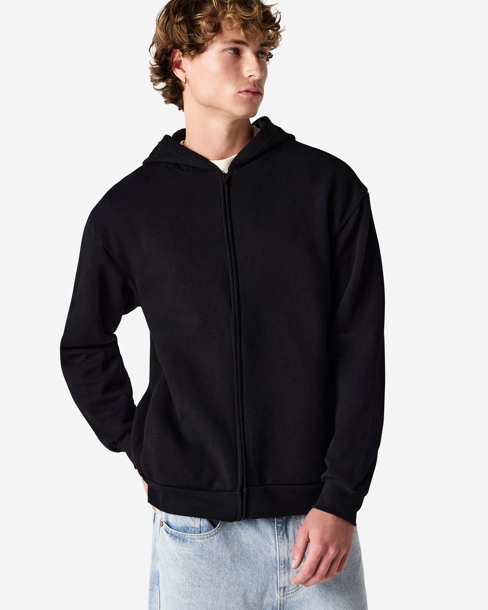 Male model wearing Reflex Unisex Full Zip Hooded Sweatshirt pairing with blue jeans (front pose) -black