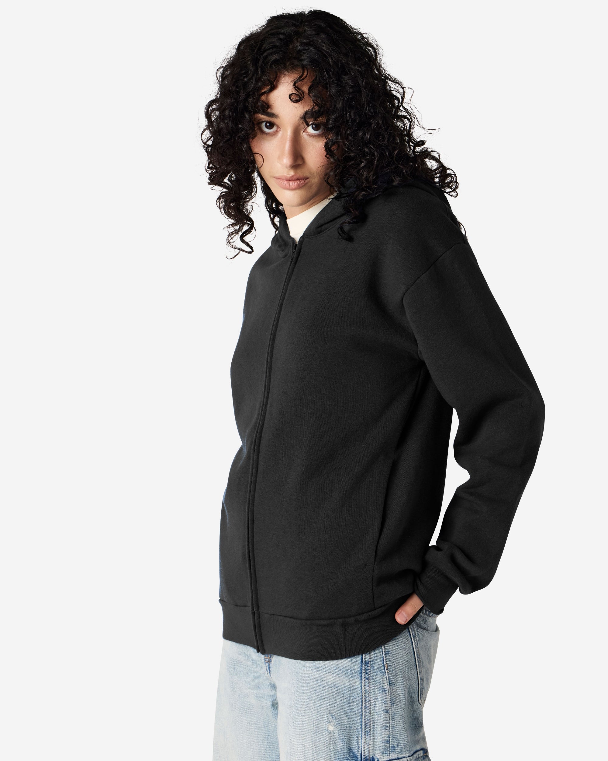 Female model wearing Reflex Unisex Full Zip Hooded Sweatshirt pairing with blue jeans (front pose) -black