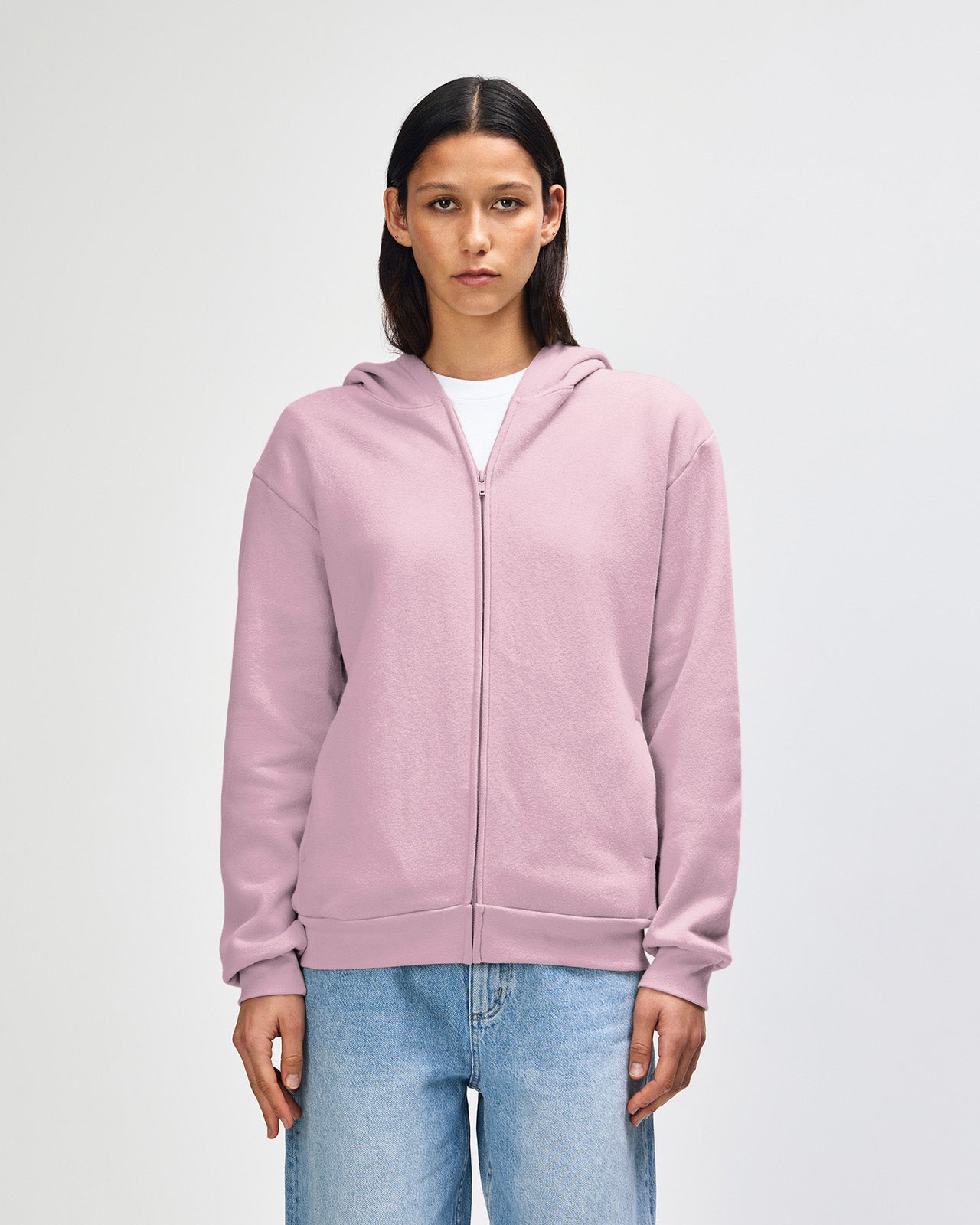 Female model wearing Reflex Unisex Full Zip Hooded Sweatshirt pairing with blue jeans (front pose) -blush