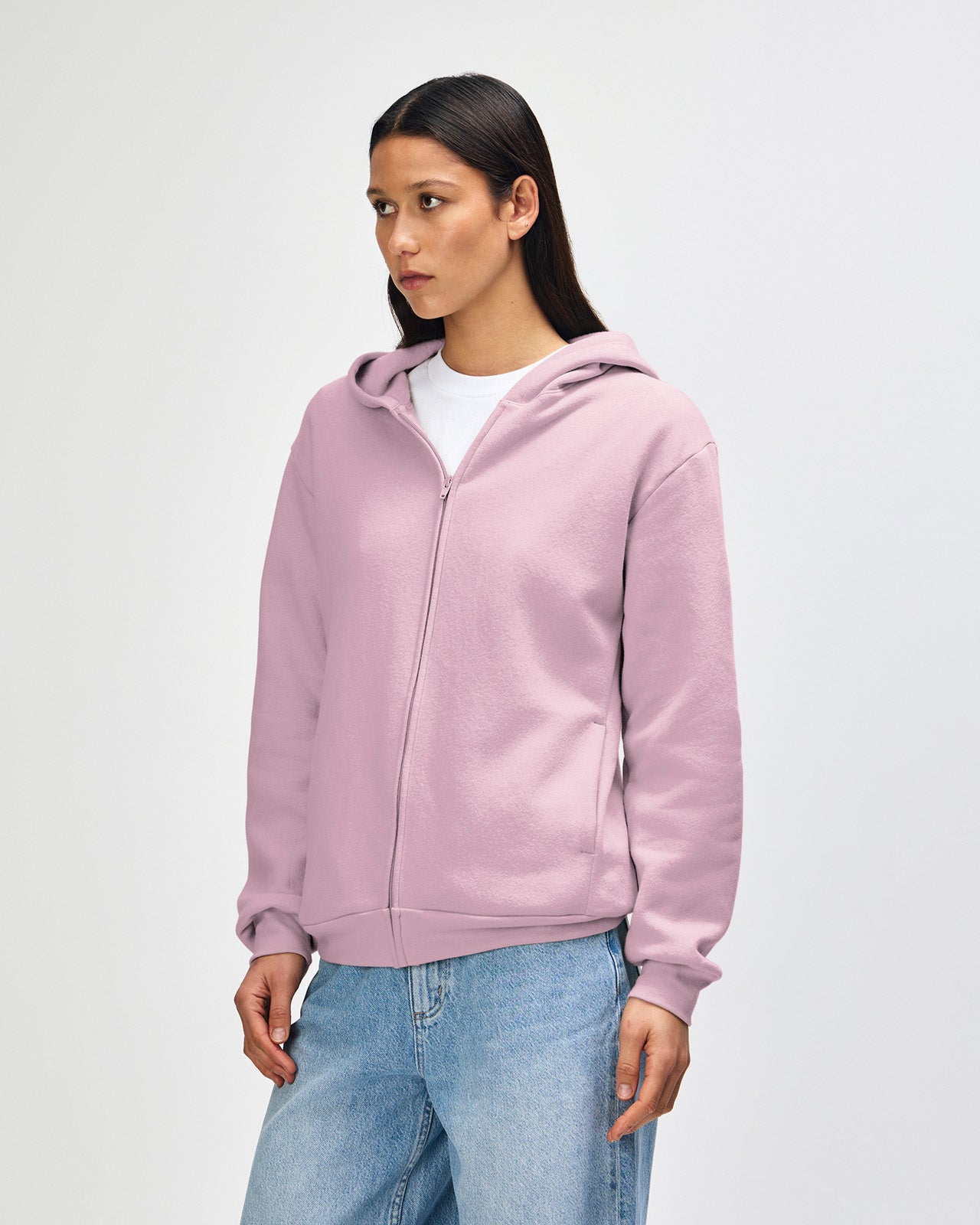Female model wearing Reflex Unisex Full Zip Hooded Sweatshirt pairing with blue jeans (front pose) -blush