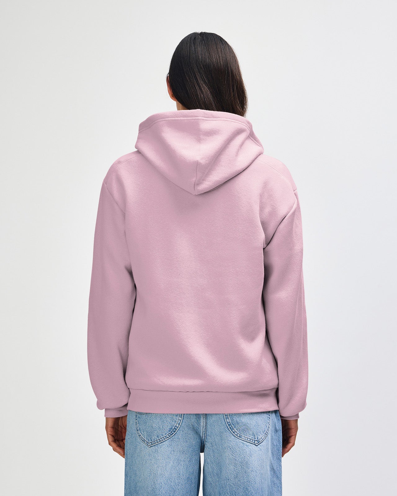Female model wearing Reflex Unisex Full Zip Hooded Sweatshirt pairing with blue jeans (back pose) -blush