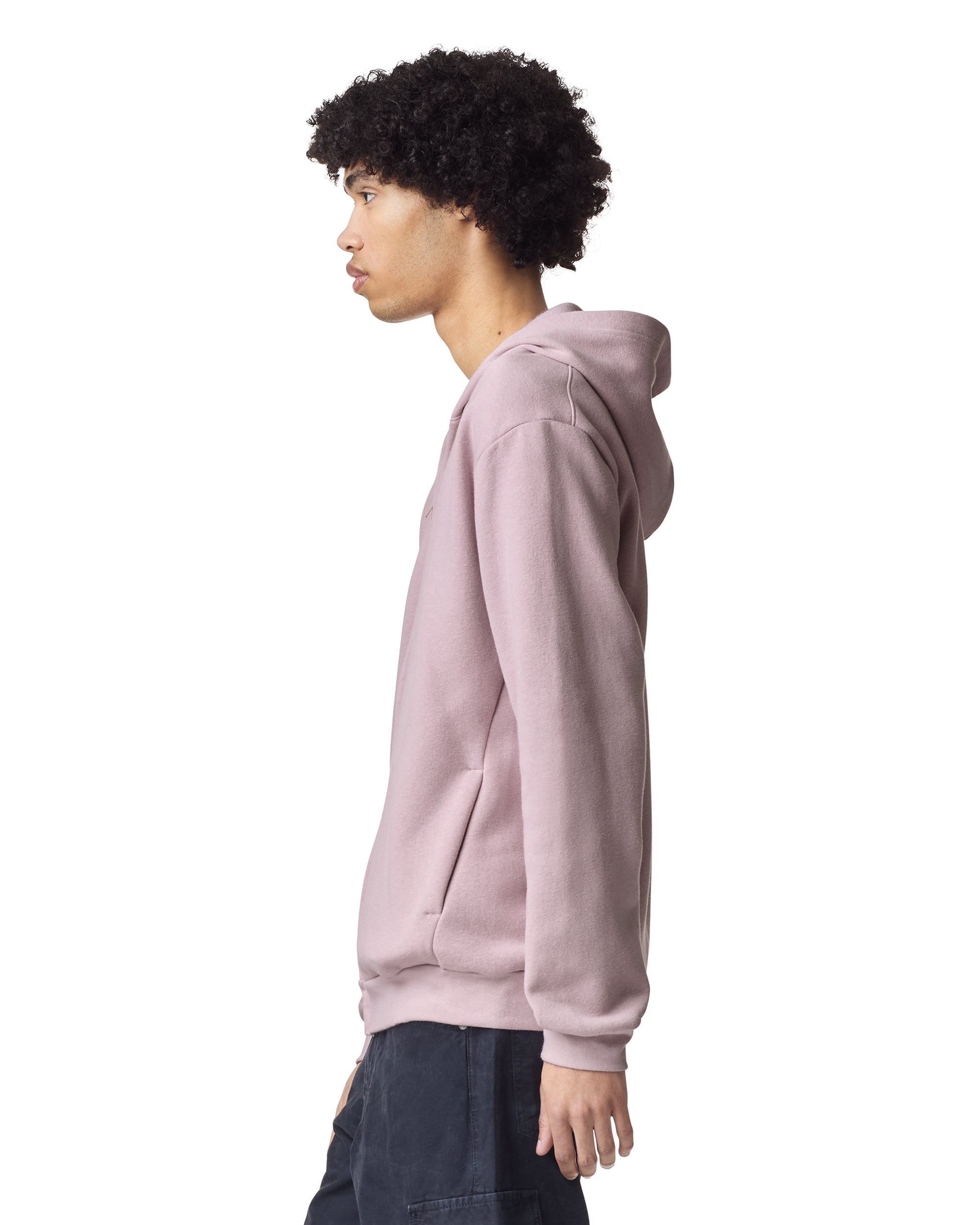 Male model wearing Reflex Unisex Full Zip Hooded Sweatshirt pairing with black jeans (side pose) -blush