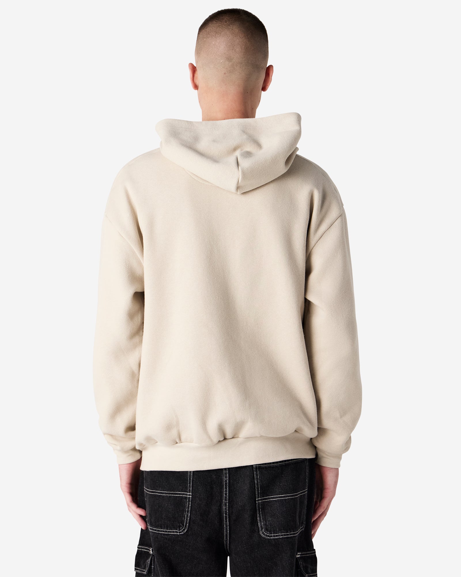 Male model wearing Reflex Unisex Full Zip Hooded Sweatshirt pairing with black jeans (back pose) -bone