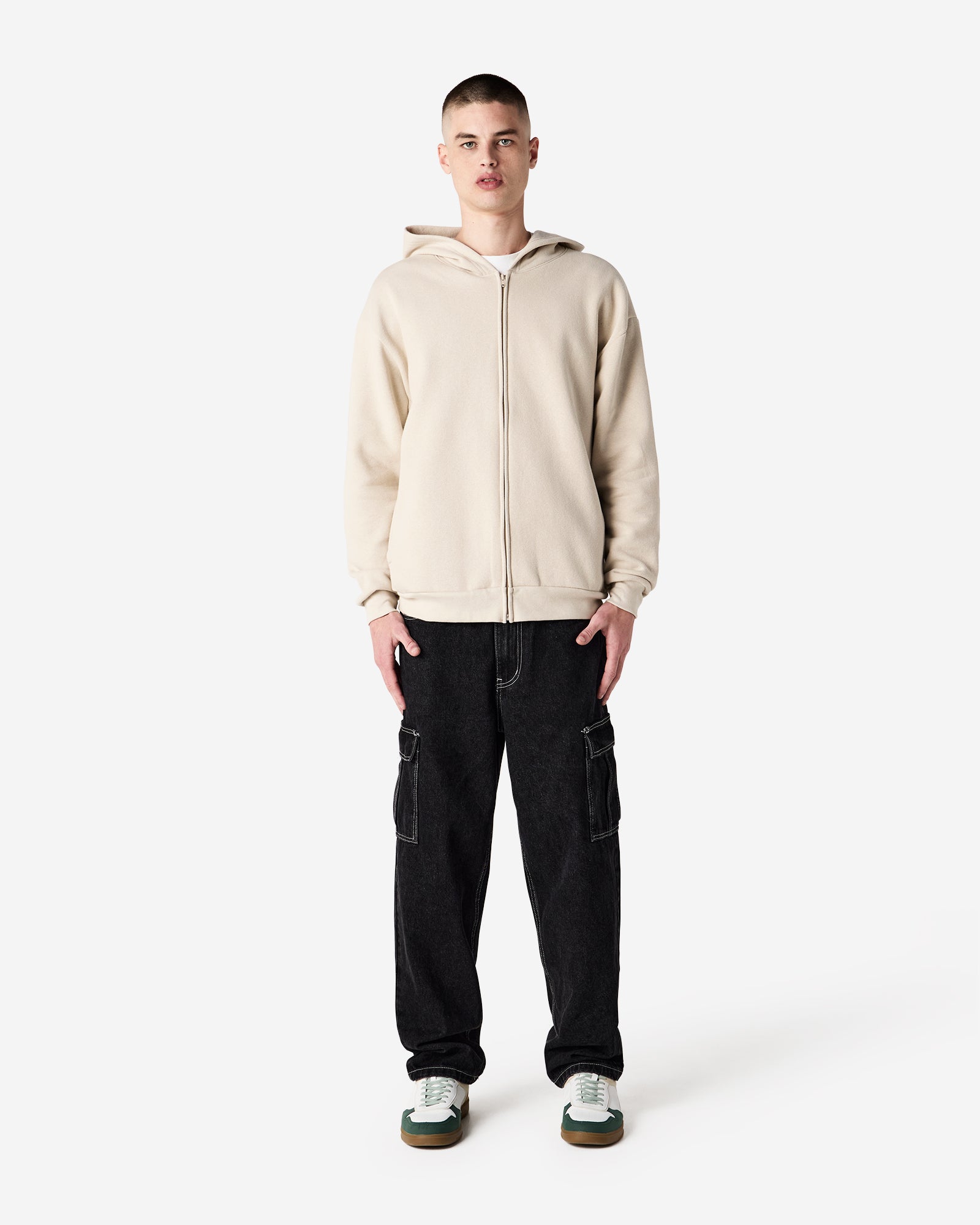 Male model wearing Reflex Unisex Full Zip Hooded Sweatshirt pairing with blue jeans (front pose) -bone