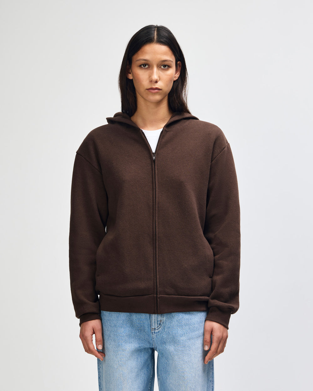 image of Unisex Zip Hoodie : Female model wearing Reflex Unisex Full Zip Hooded Sweatshirt pairing with blue jeans (front pose) -brown