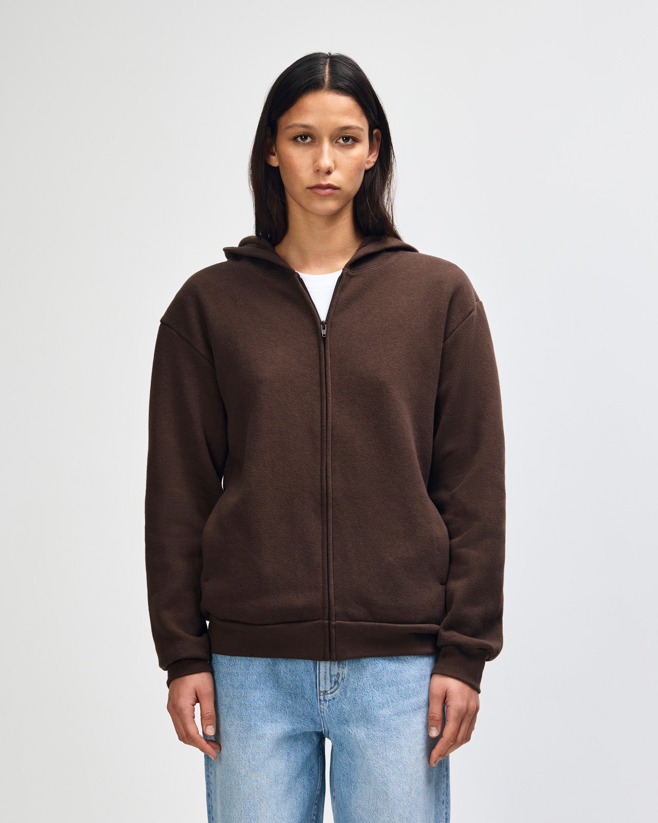Female model wearing Reflex Unisex Full Zip Hooded Sweatshirt pairing with blue jeans (front pose) -brown