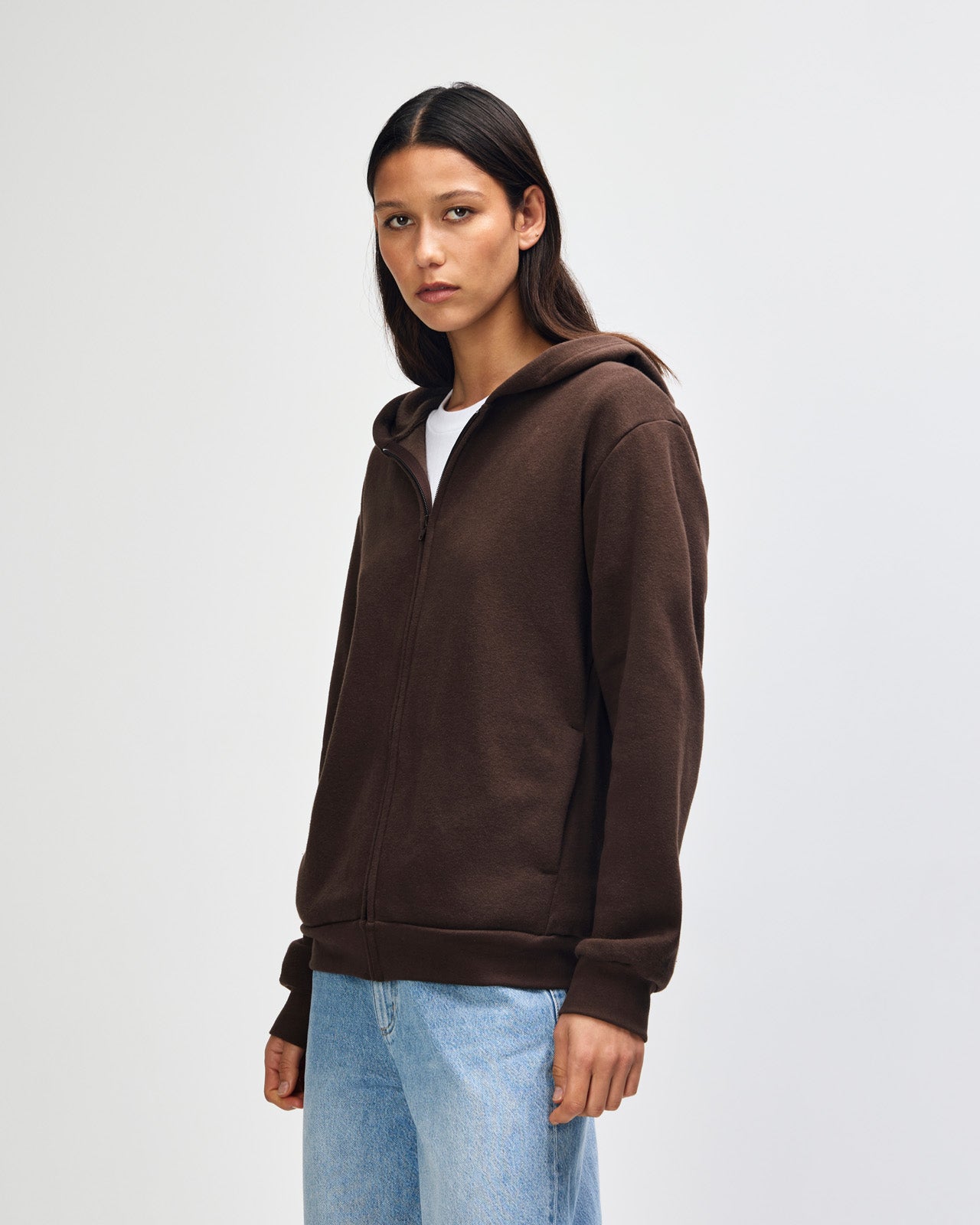 Female model wearing Reflex Unisex Full Zip Hooded Sweatshirt pairing with blue jeans (front pose) -brown