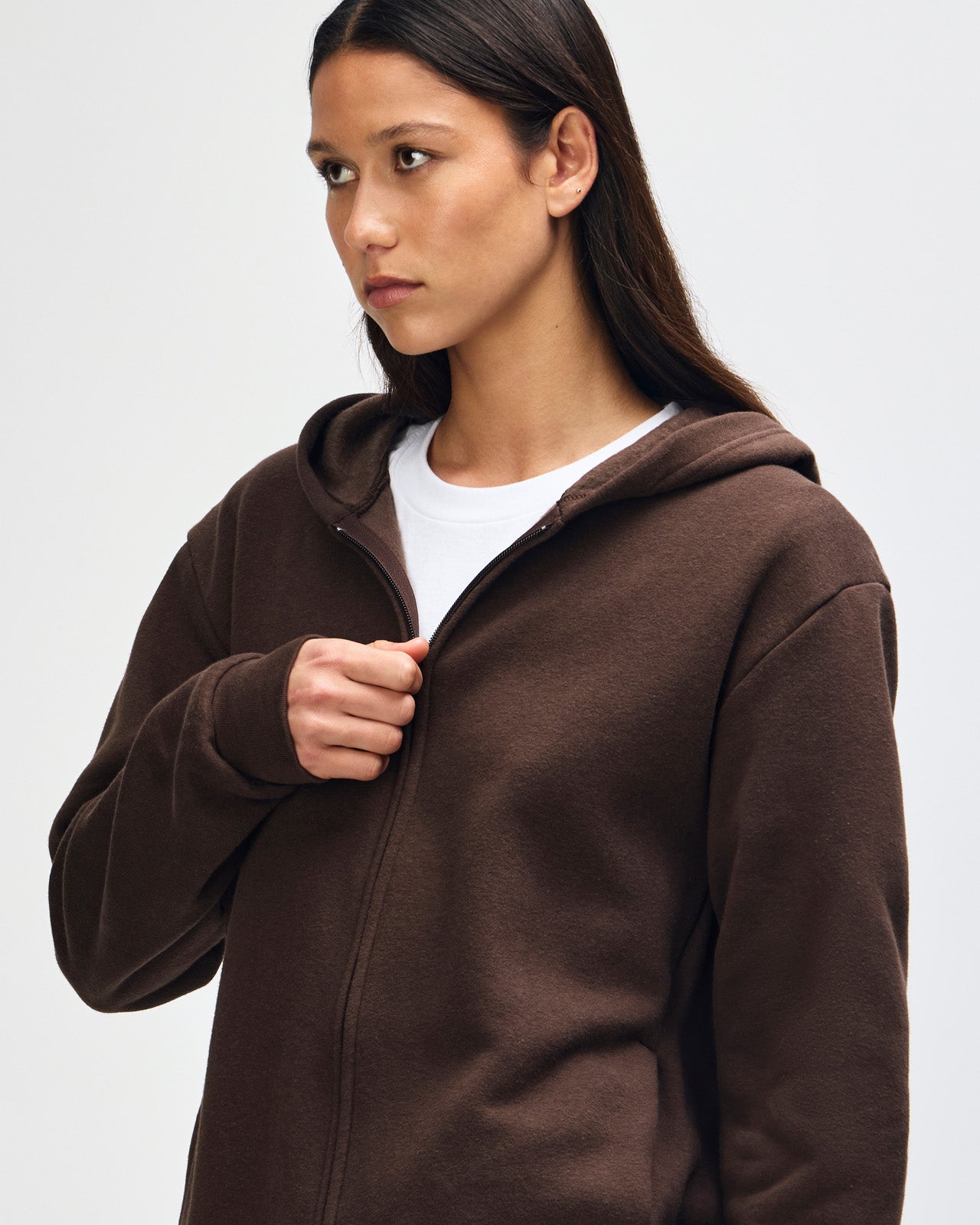 Female model wearing Reflex Unisex Full Zip Hooded Sweatshirt pairing with blue jeans (close up pose) -brown