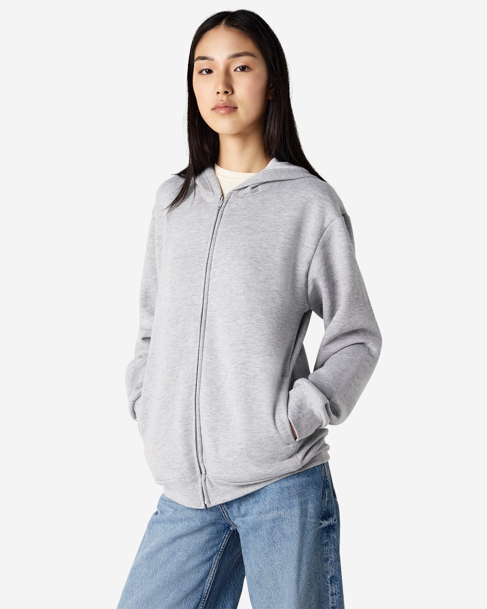 Female model wearing Reflex Unisex Full Zip Hooded Sweatshirt pairing with blue jeans (front pose) -heather grey