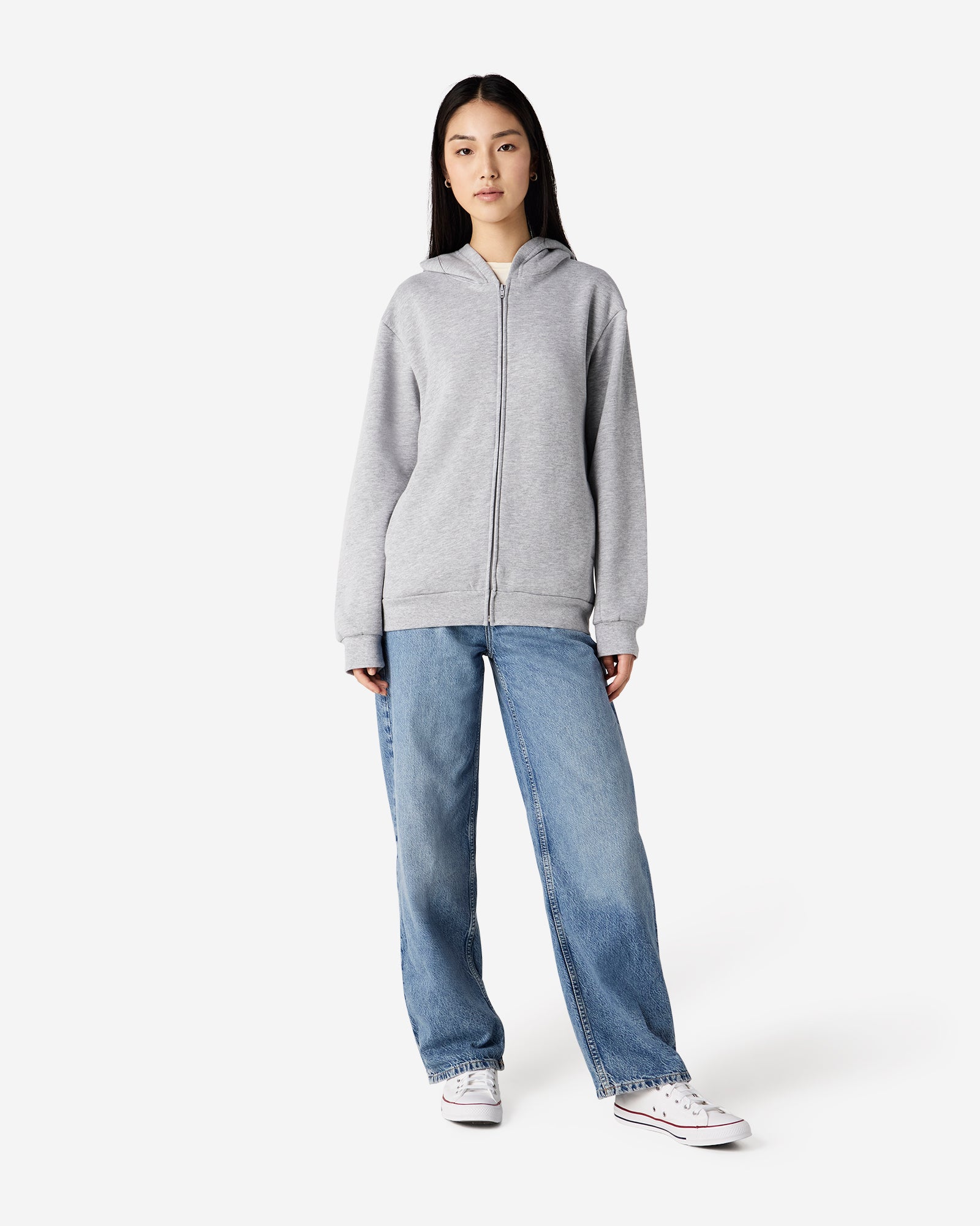 Female model wearing Reflex Unisex Full Zip Hooded Sweatshirt pairing with blue jeans (front pose) -heather grey