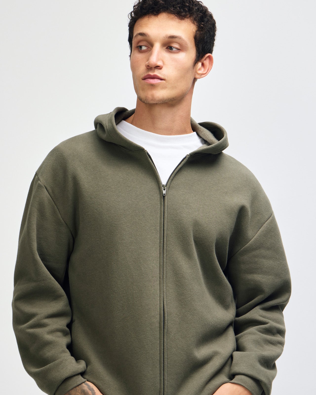 Male model wearing Reflex Unisex Full Zip Hooded Sweatshirt pairing with blue jeans (front pose) - lieutenant