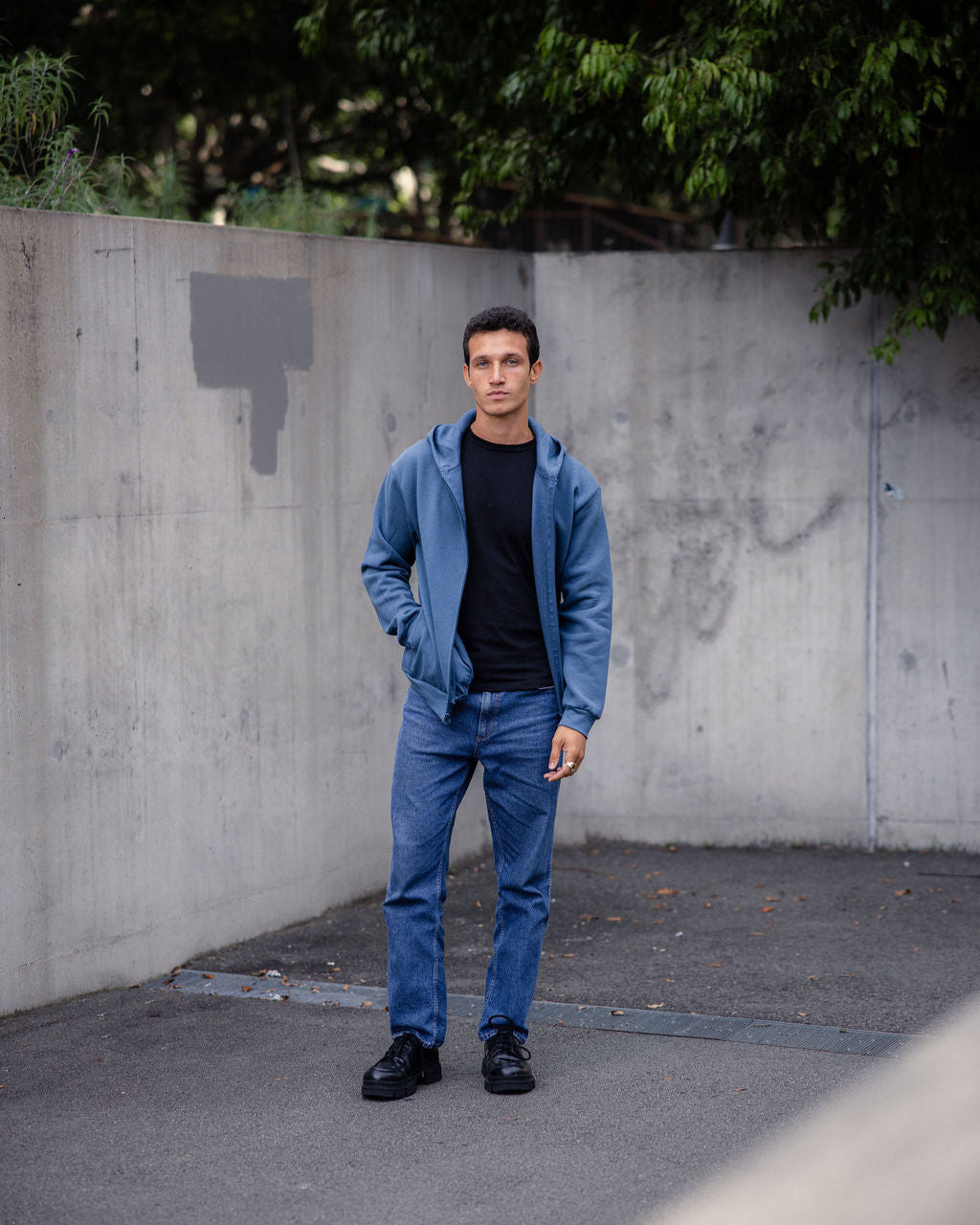 Male model wearing Reflex Unisex Full Zip Hooded Sweatshirt pairing with blue jeans (front pose) -sea blue