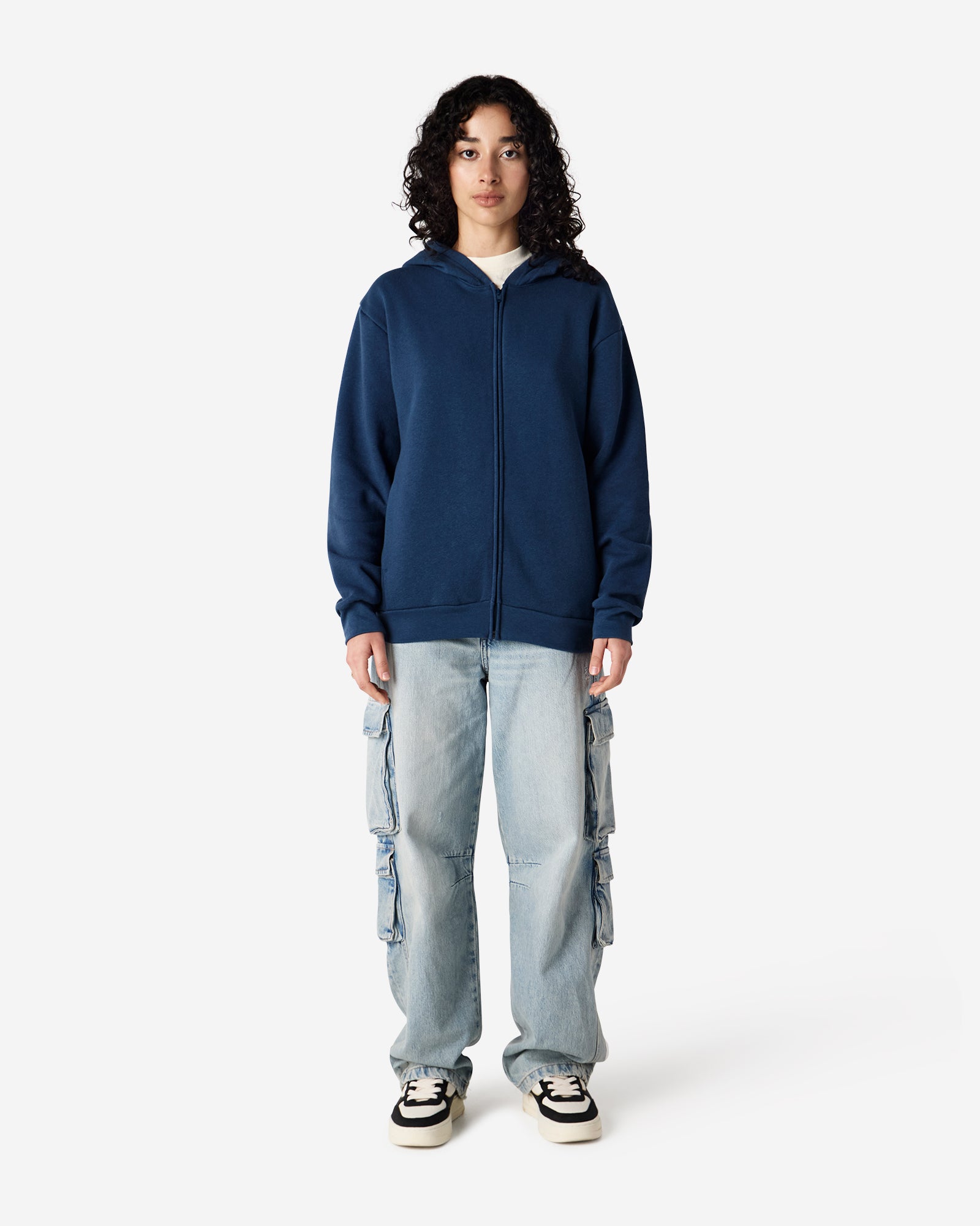 Female model wearing Reflex Unisex Full Zip Hooded Sweatshirt pairing with blue jeans (front pose) -sea blue