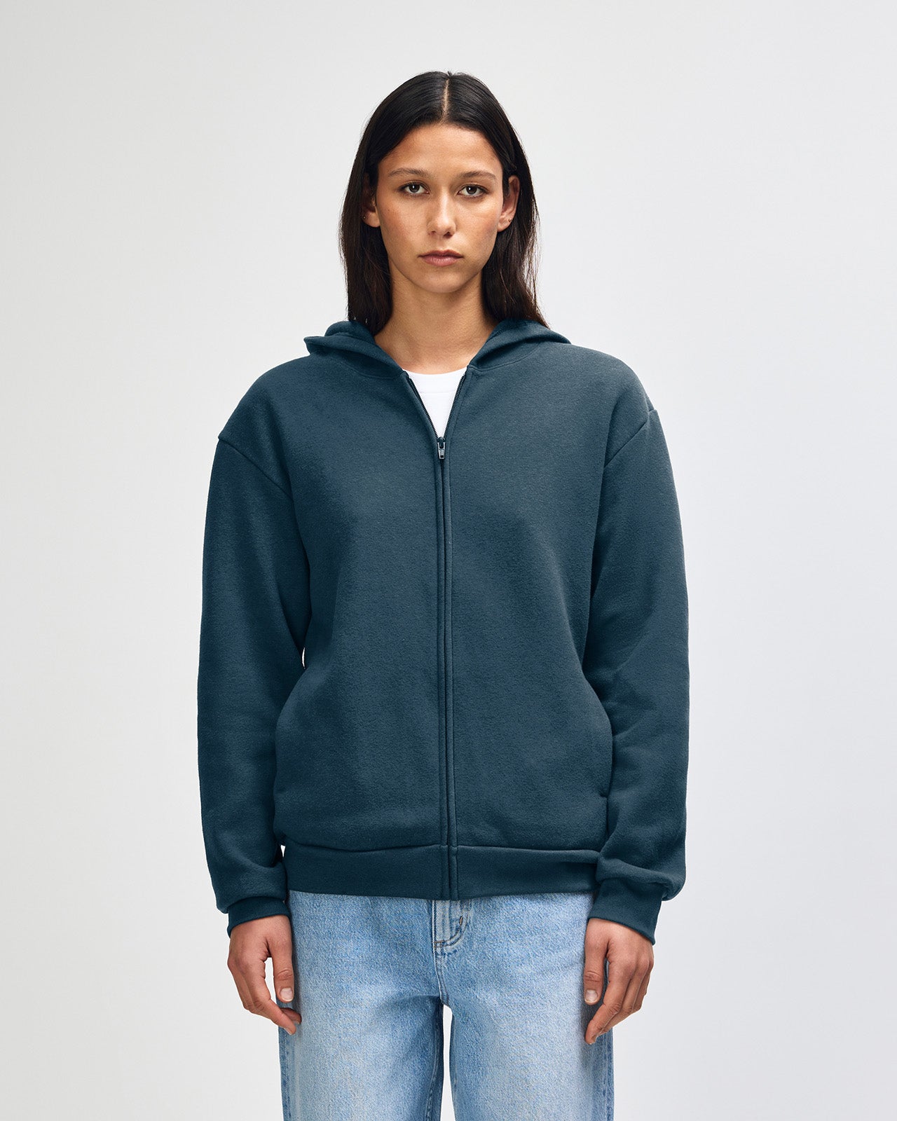 Female model wearing Reflex Unisex Full Zip Hooded Sweatshirt pairing with blue jeans (front pose) - sea blue