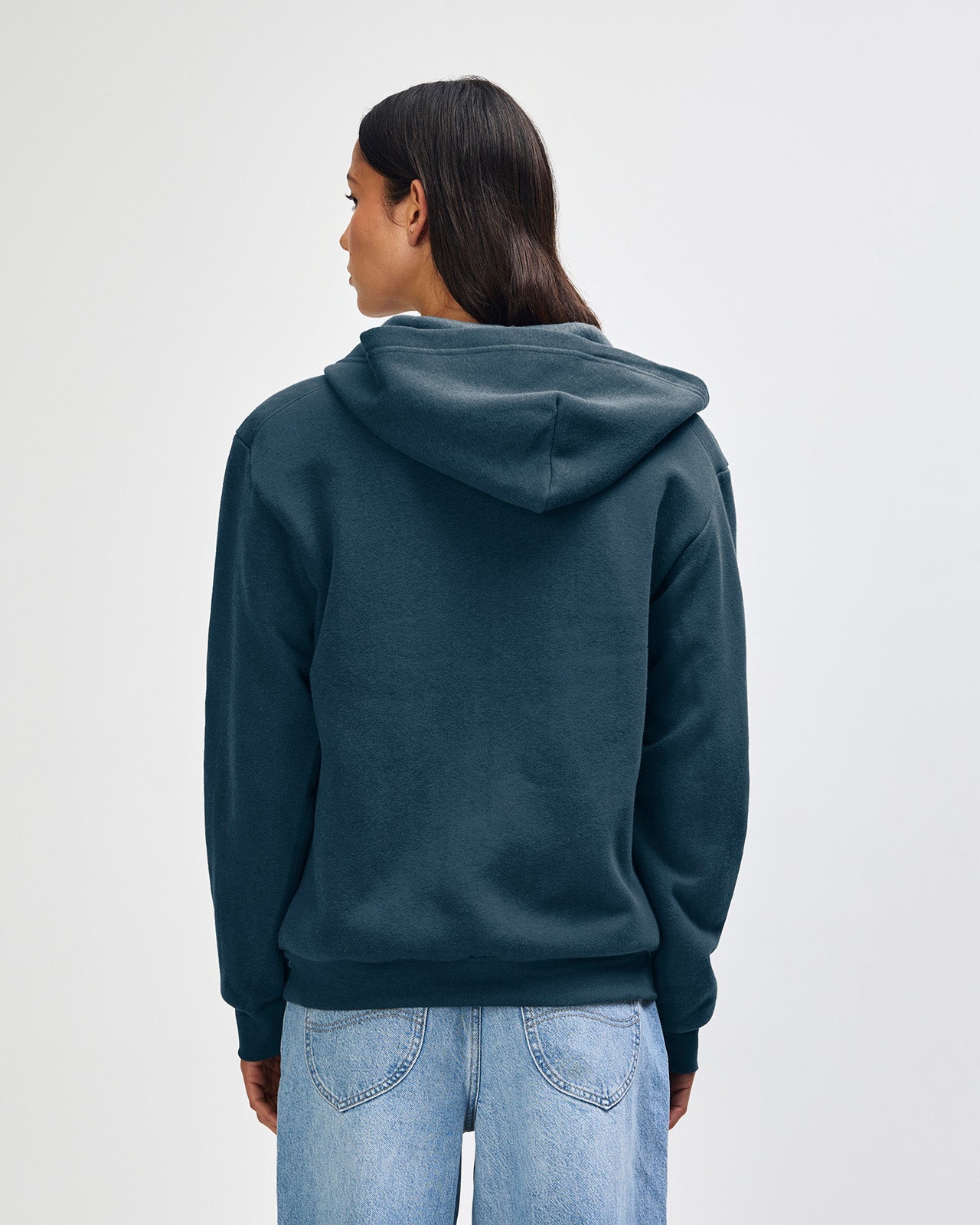Female model wearing Reflex Unisex Full Zip Hooded Sweatshirt pairing with blue jeans (front pose) -sea blue