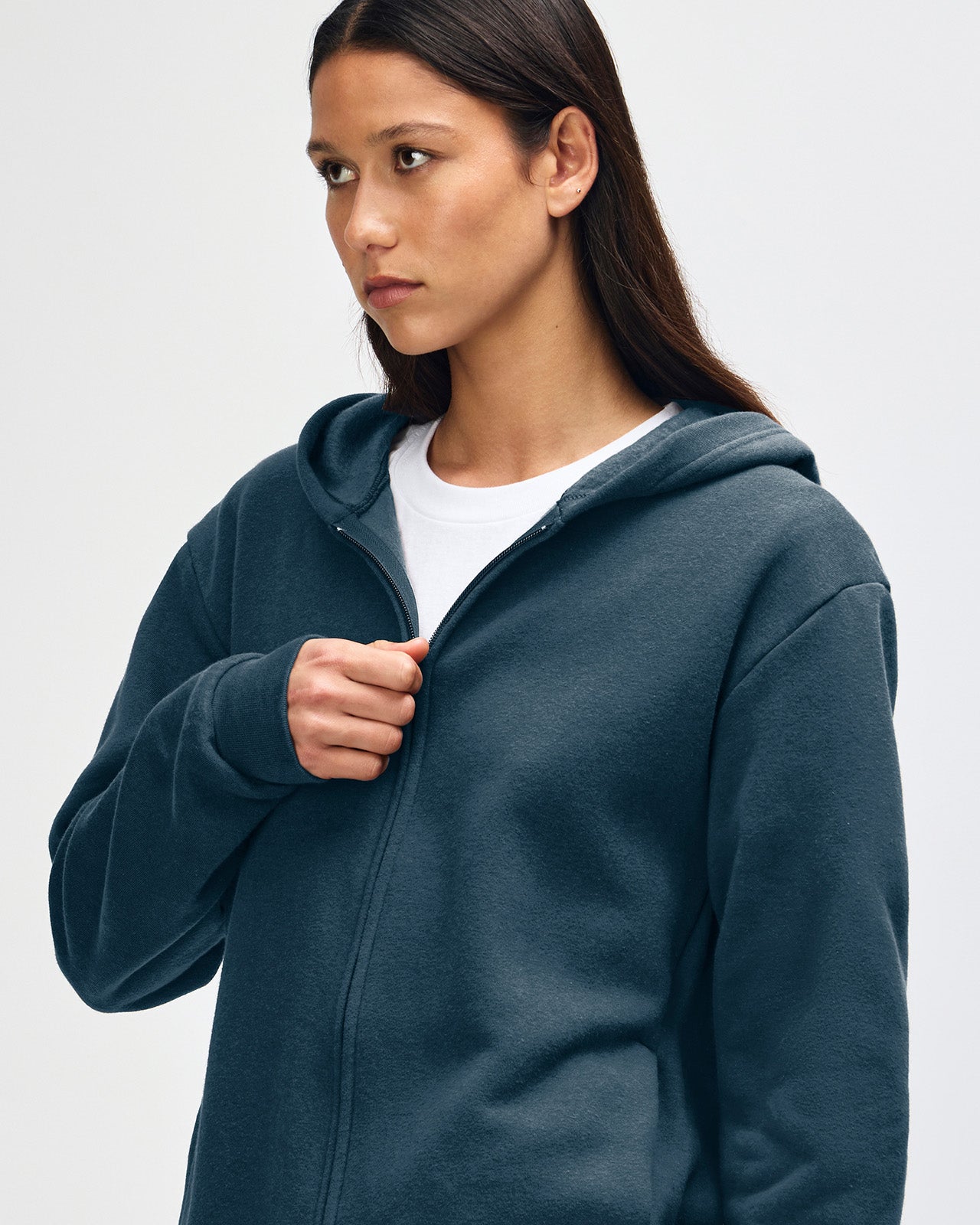 Female model wearing Reflex Unisex Full Zip Hooded Sweatshirt pairing with blue jeans (front pose) -sea blue