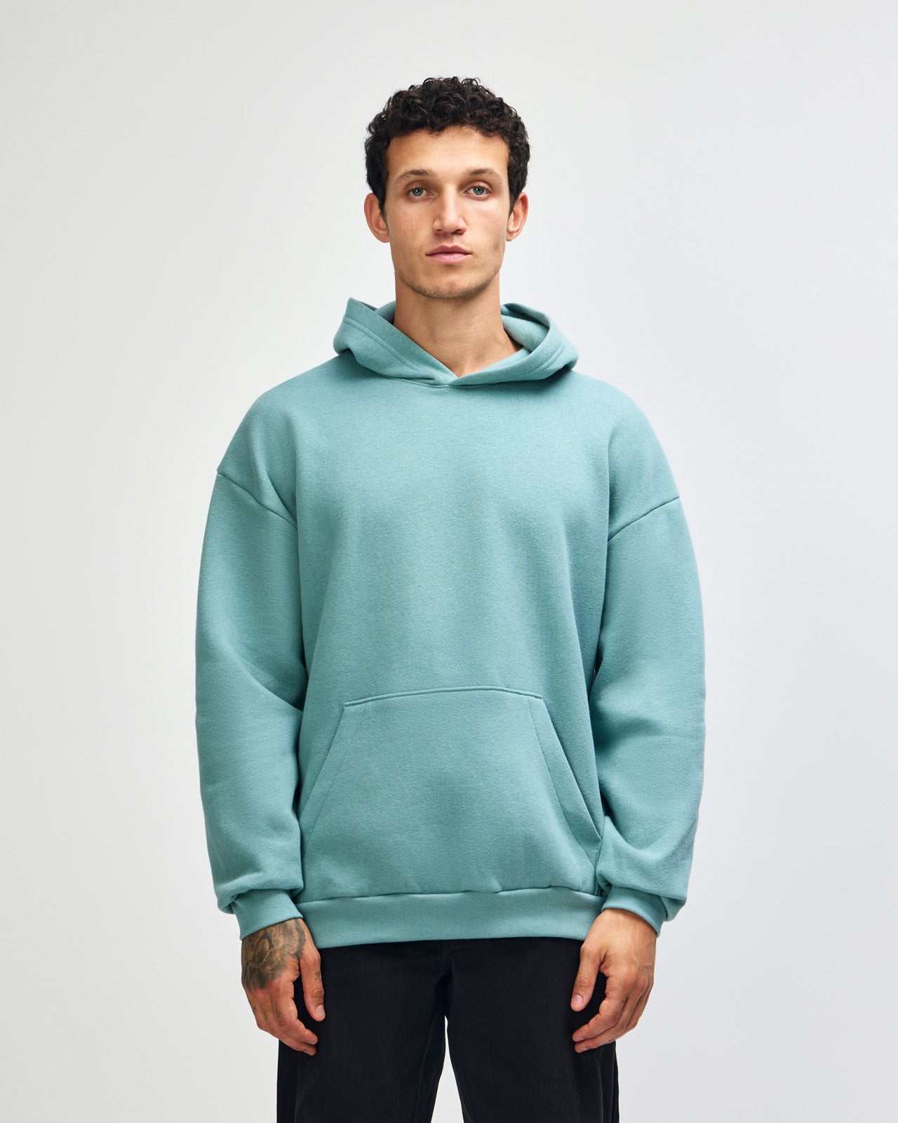 Male model wearing a Reflex Unisex Hooded Sweatshirt (front pose) -arctic