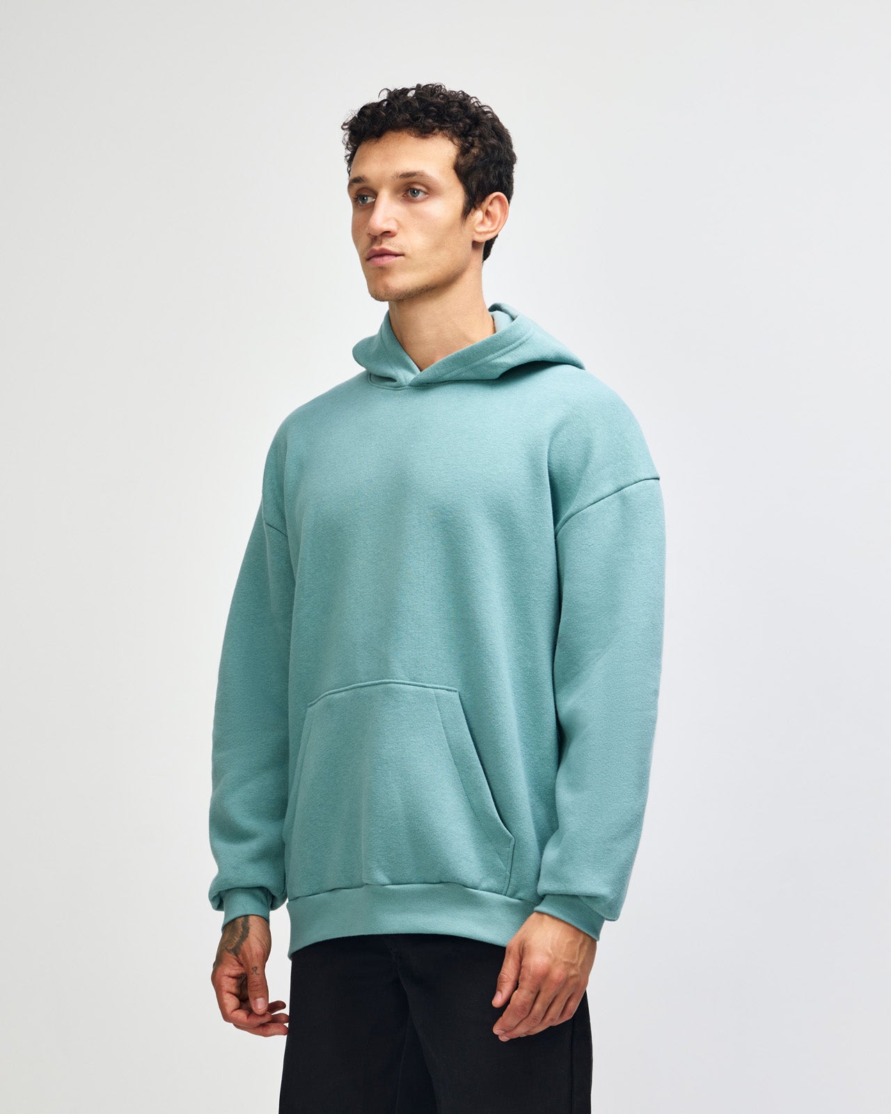 Male model wearing a Reflex Unisex Hooded Sweatshirt (front pose) -arctic