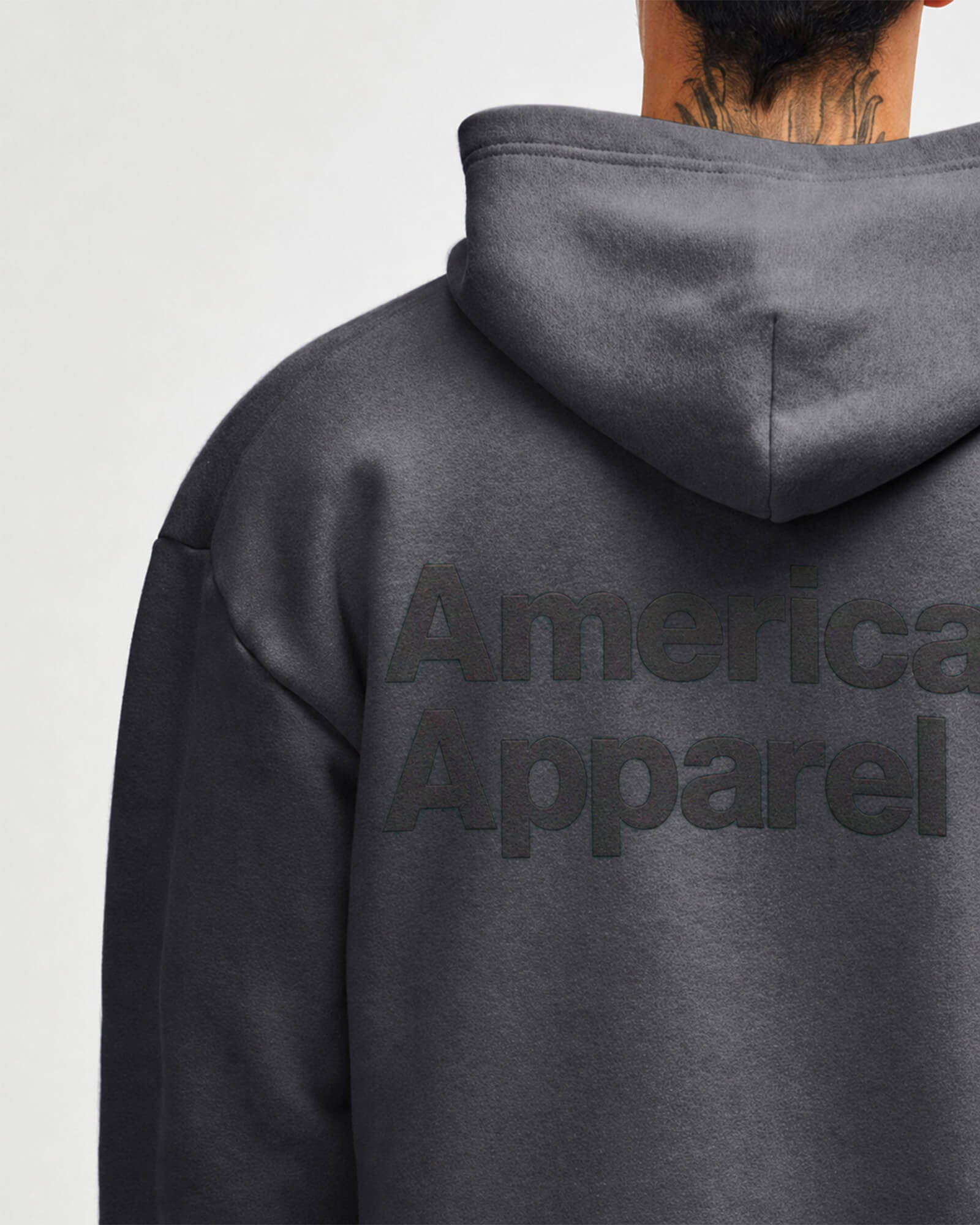 Dark gray hoodie with 'American Apparel' logo on the back against a light gray background -Asphalt