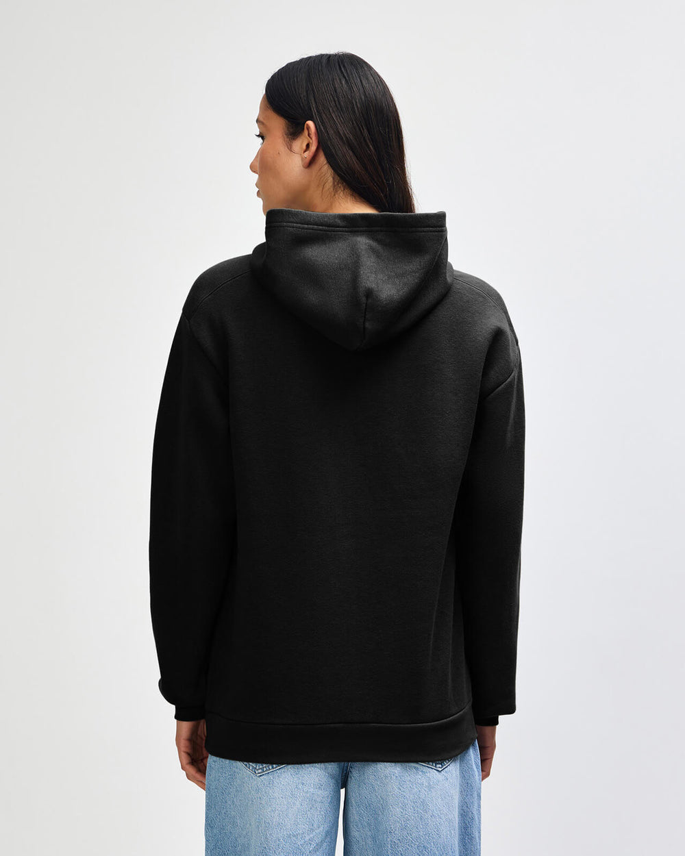 next image of Pullover Hoodie Tracksuit Set - Embroidered Logo - Black : Person wearing a black hoodie from behind on a light gray background -black