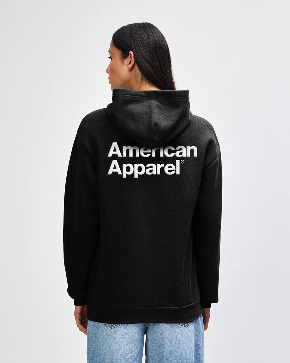 next image of Pullover Hoodie Tracksuit - Puff Logo - Black : Person wearing a black hoodie with 'American Apparel' logo on the back against a white background -black
