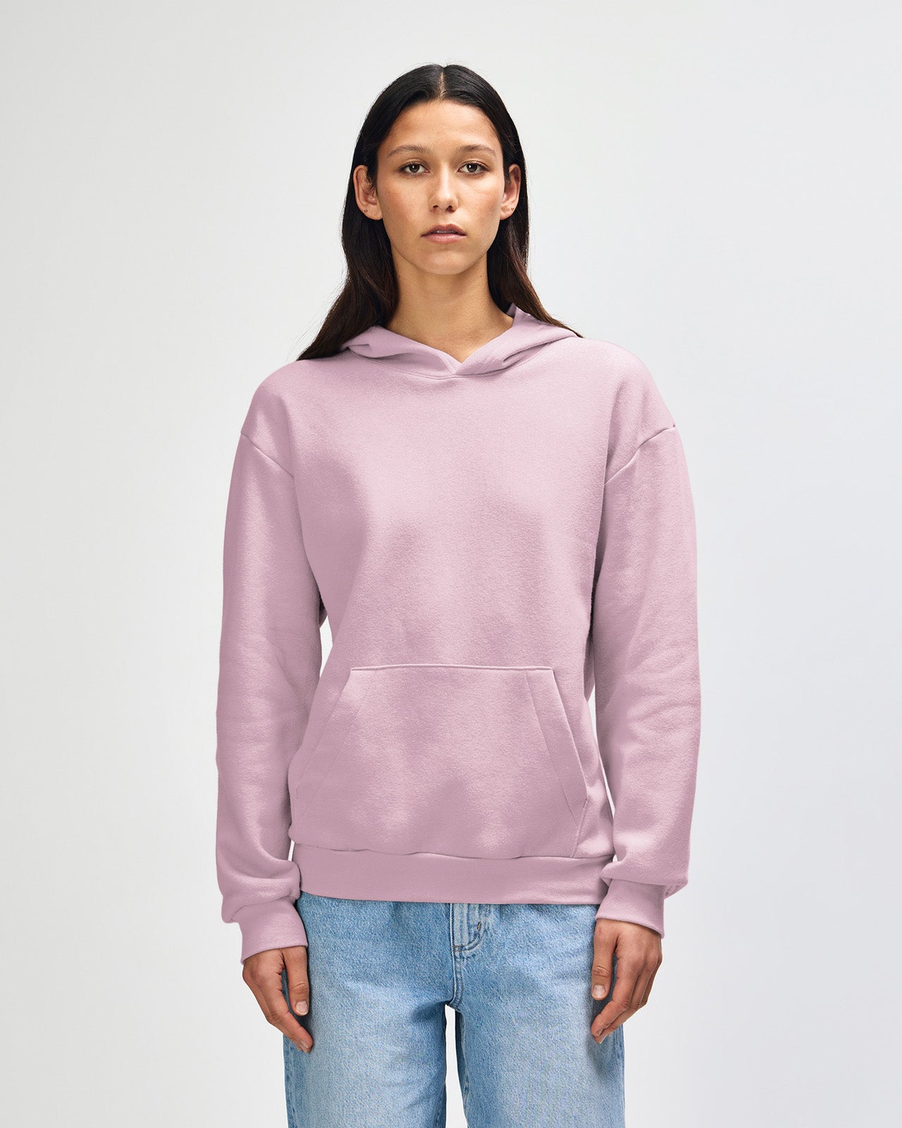 Femle model wearing a Reflex Unisex Hooded Sweatshirt (front pose) - Blush