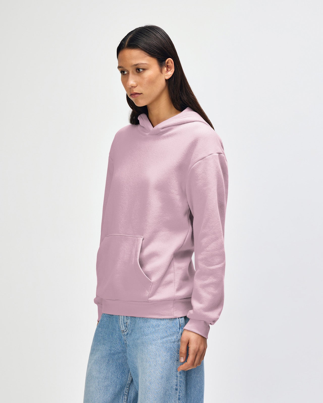 Femle model wearing a Reflex Unisex Hooded Sweatshirt (front pose) - Blush