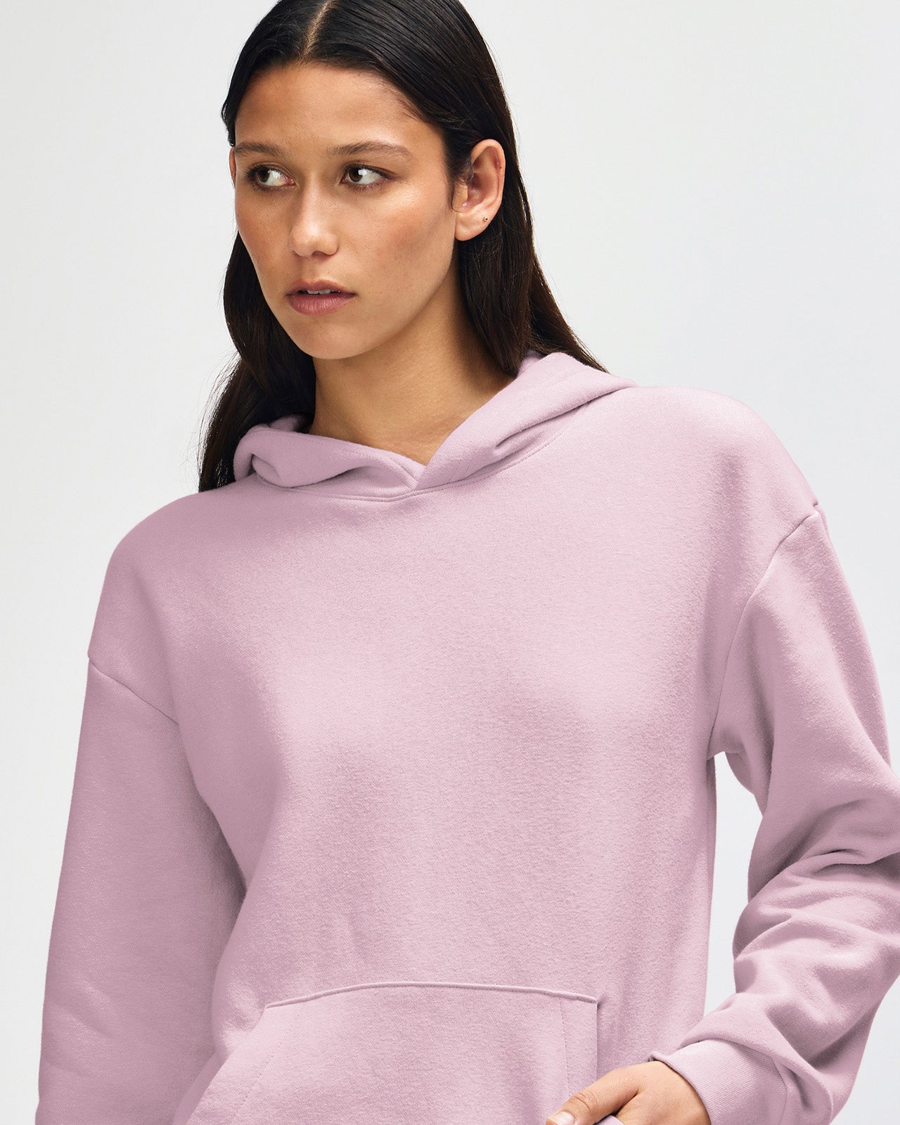 Femle model wearing a Reflex Unisex Hooded Sweatshirt (front pose) - Blush